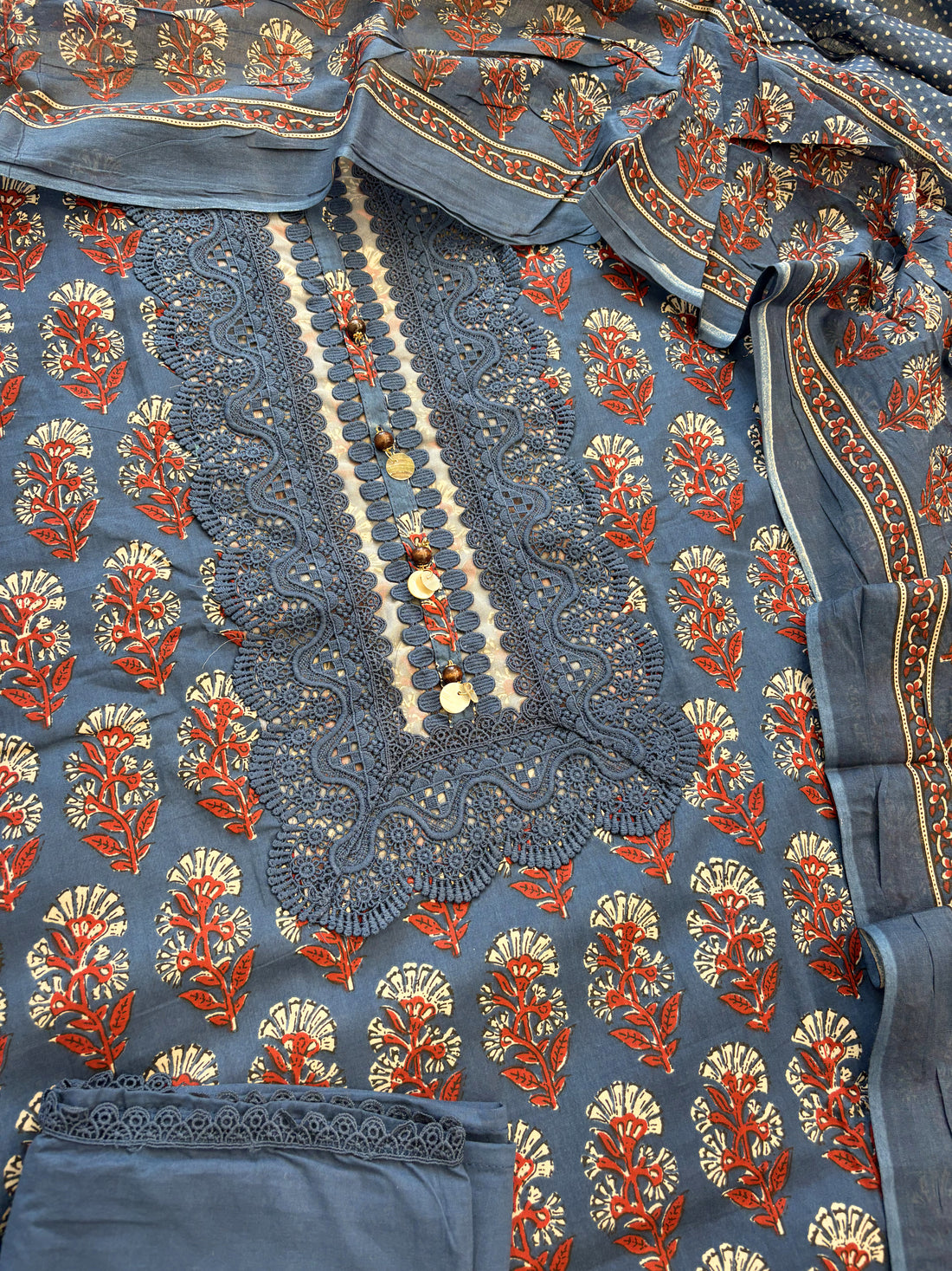 Complete navy blue cotton unstitched suit flat lay set with block print shirt, digital print dupatta, and lace trimmed cotton bottom
