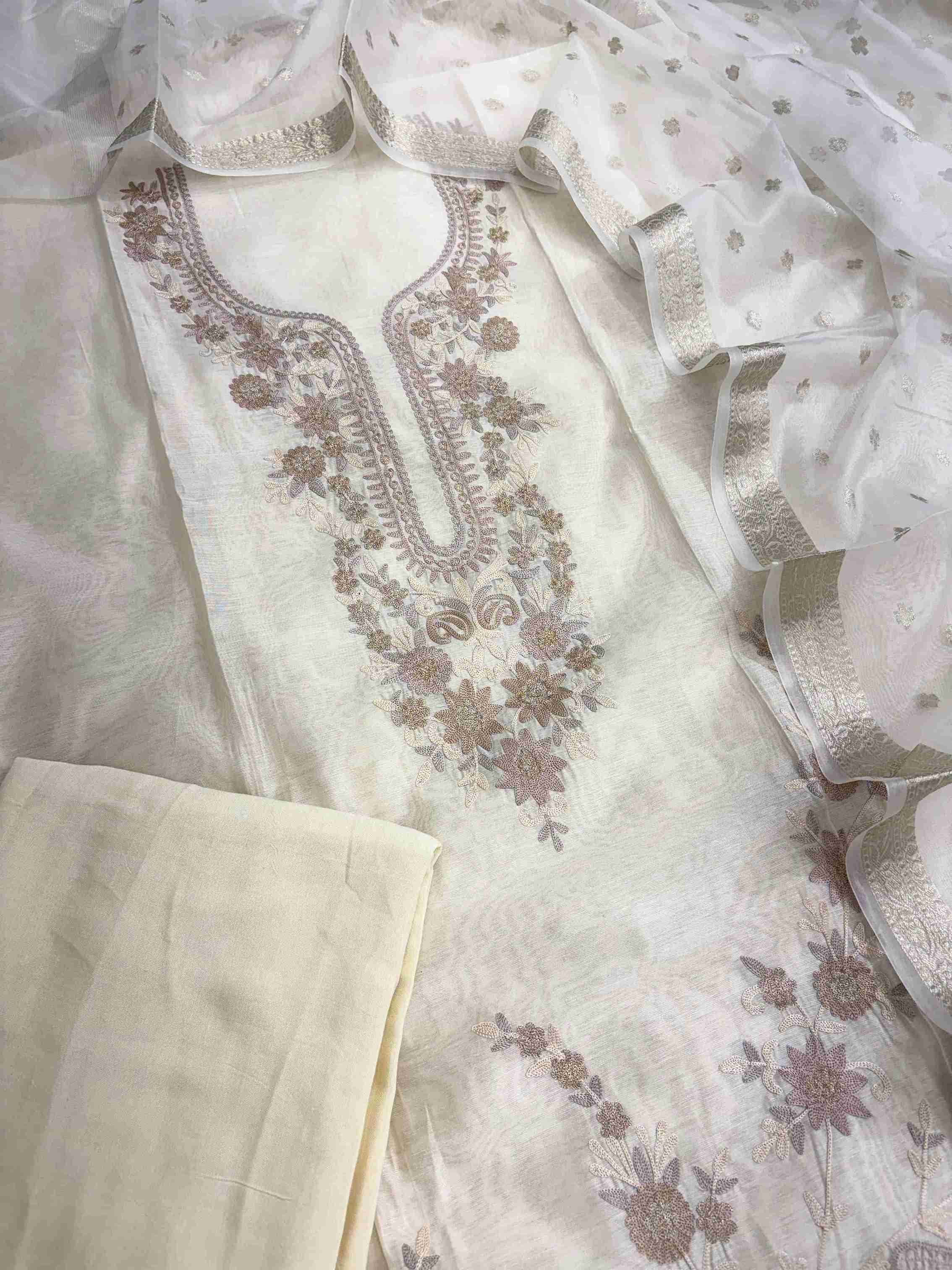 Scattered floral and paisley motifs on off-white Chanderi suit