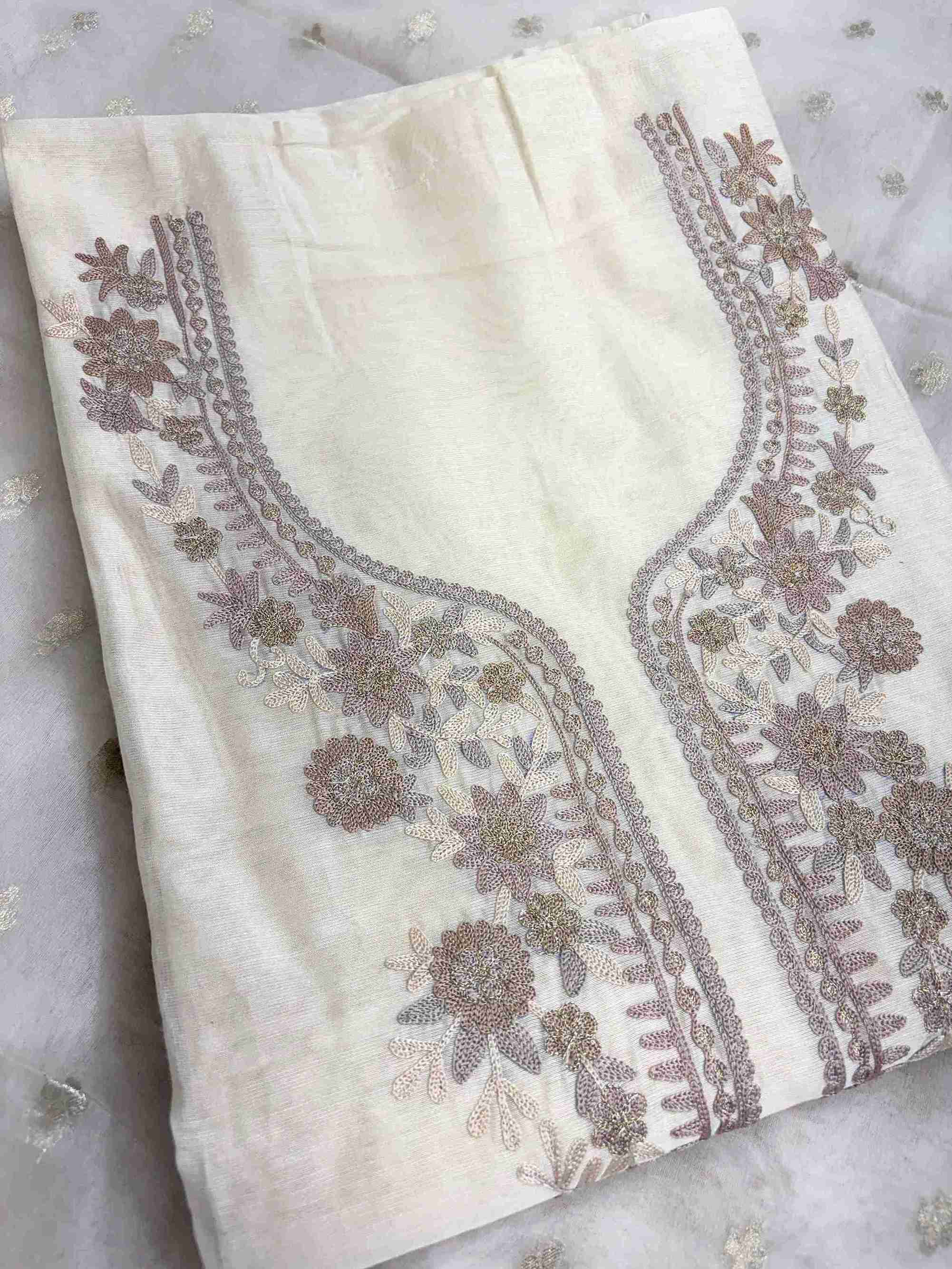 Close-up of aari work floral embroidery on off-white Chanderi suit neckline