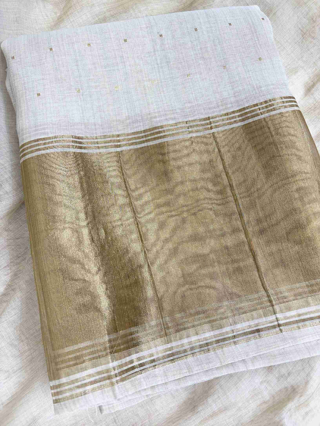 Broad gold zari patta at hemline of off-white jamdani cotton unstitched shirt