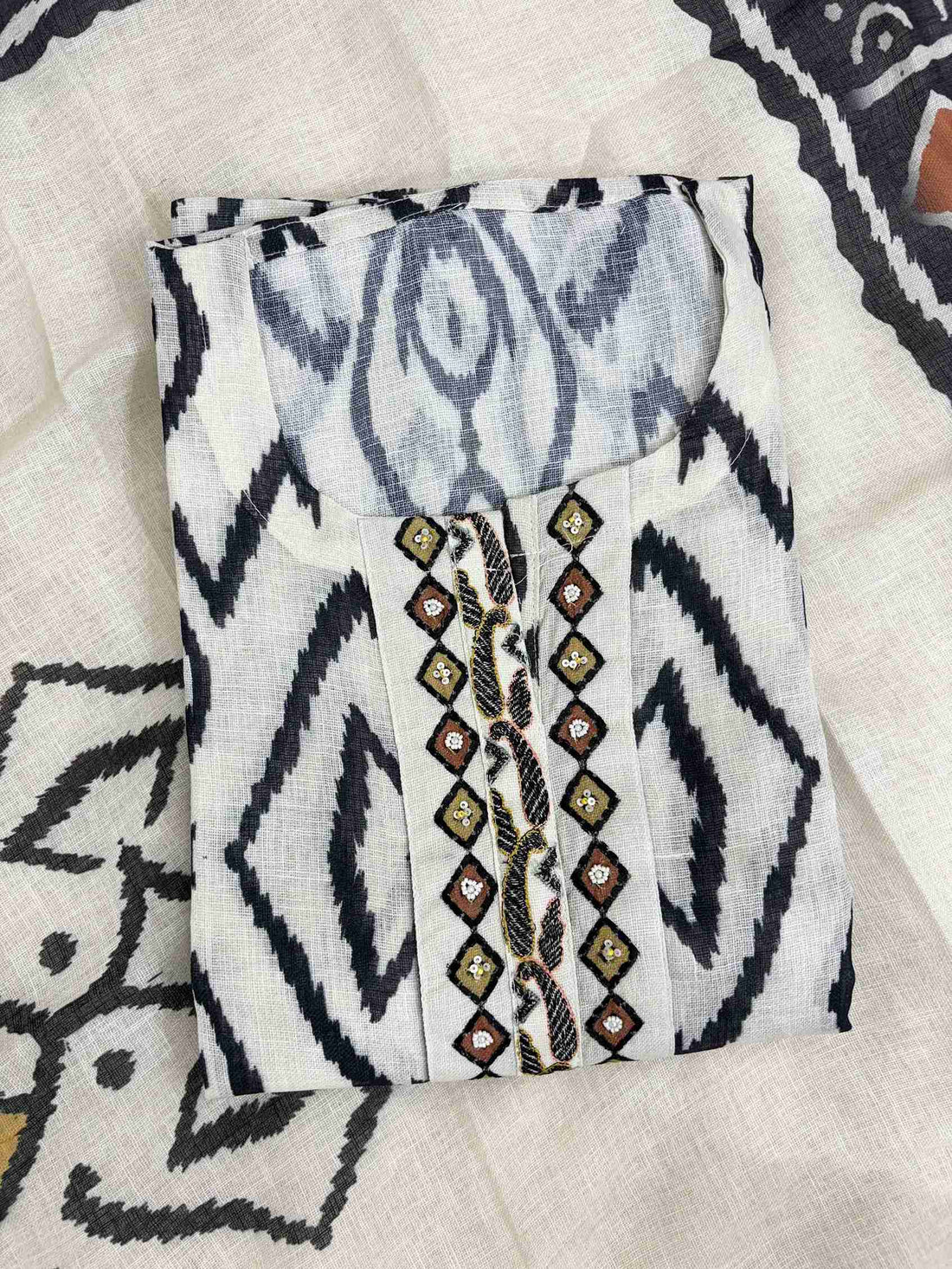 All-over black ikat geometric diamond and ogee print on off-white linen shirt body
