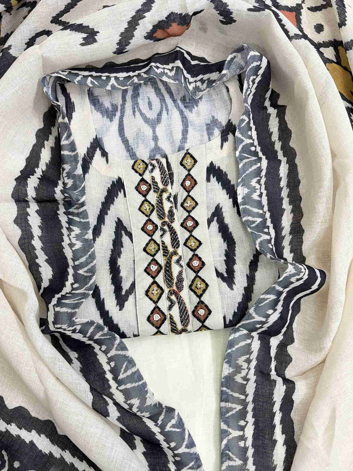 Embroidered neckline panel with multicolor thread and bead detailing on off-white black ikat linen shirt