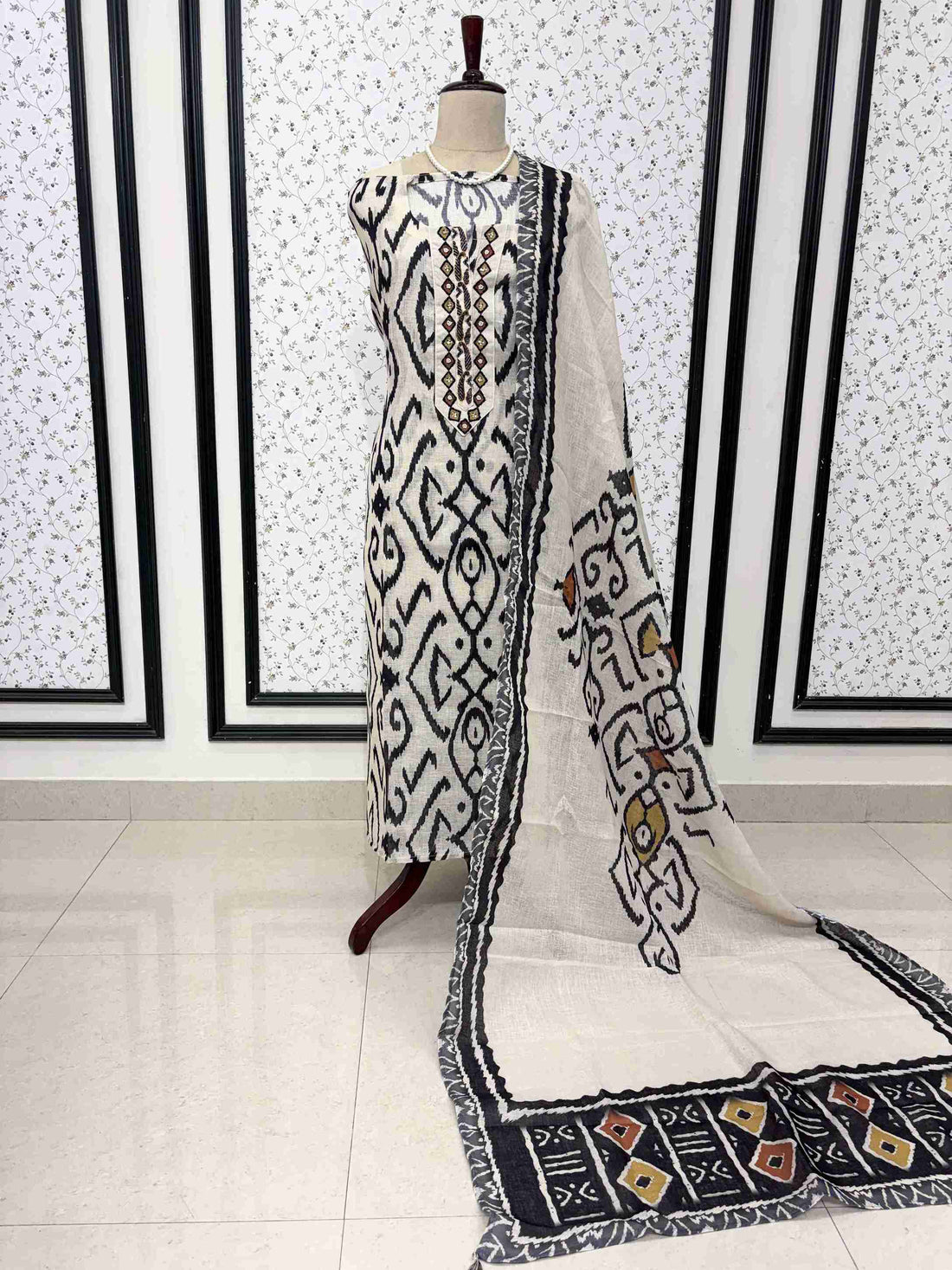 Off-white linen unstitched suit full front view with multicolor ikat border dupatta draped on mannequin