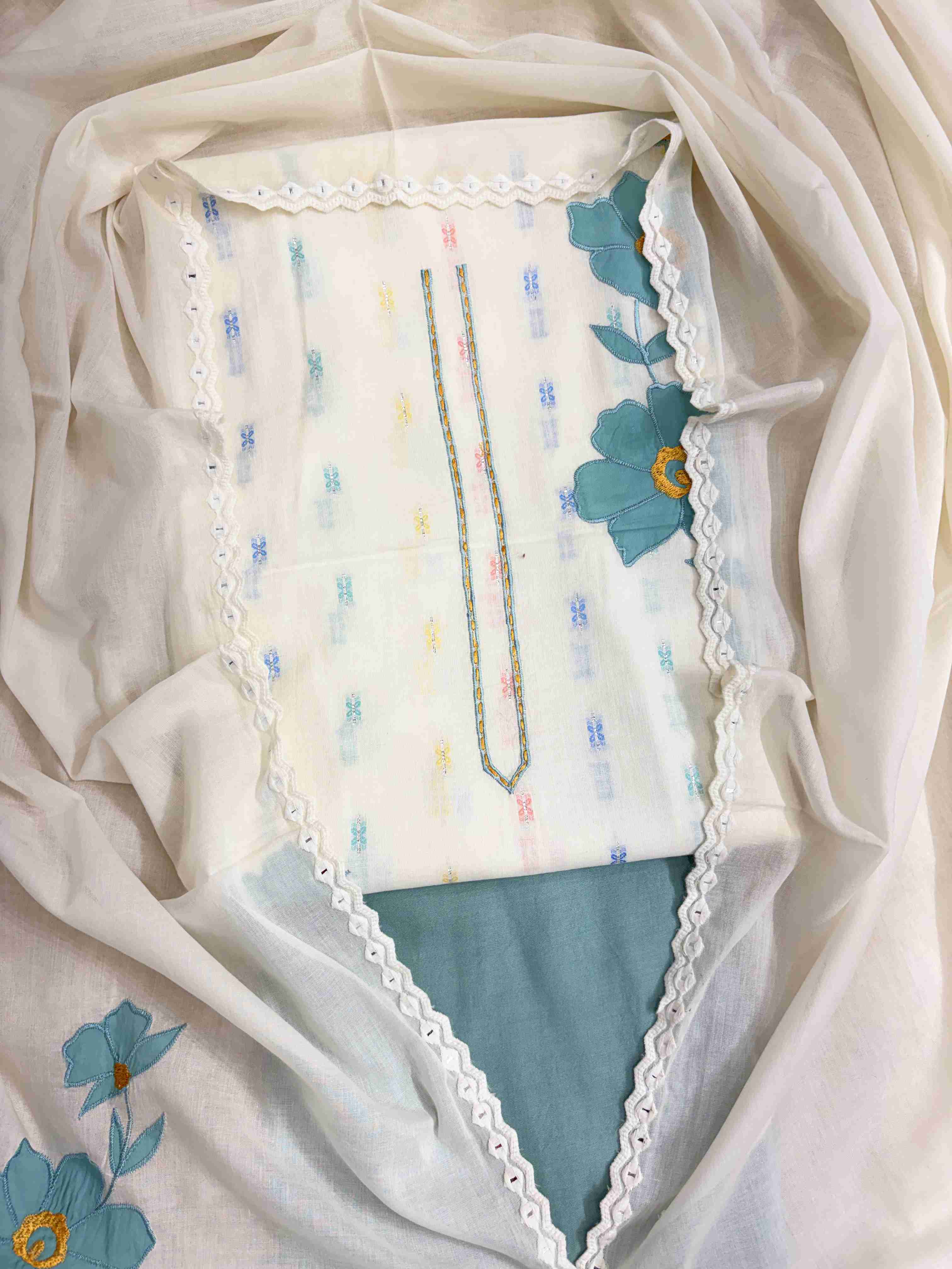 Complete off-white pure cotton unstitched suit flat lay set with shirt, dupatta, and teal blue cotton bottom