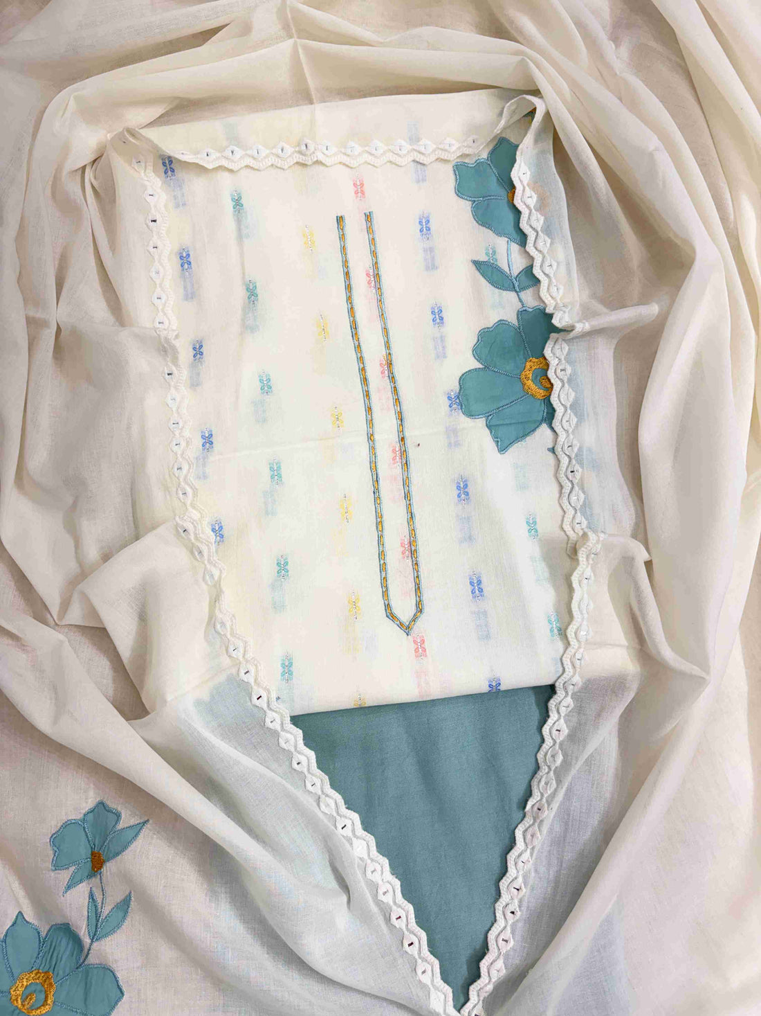 Complete off-white pure cotton unstitched suit flat lay set with shirt, dupatta, and teal blue cotton bottom