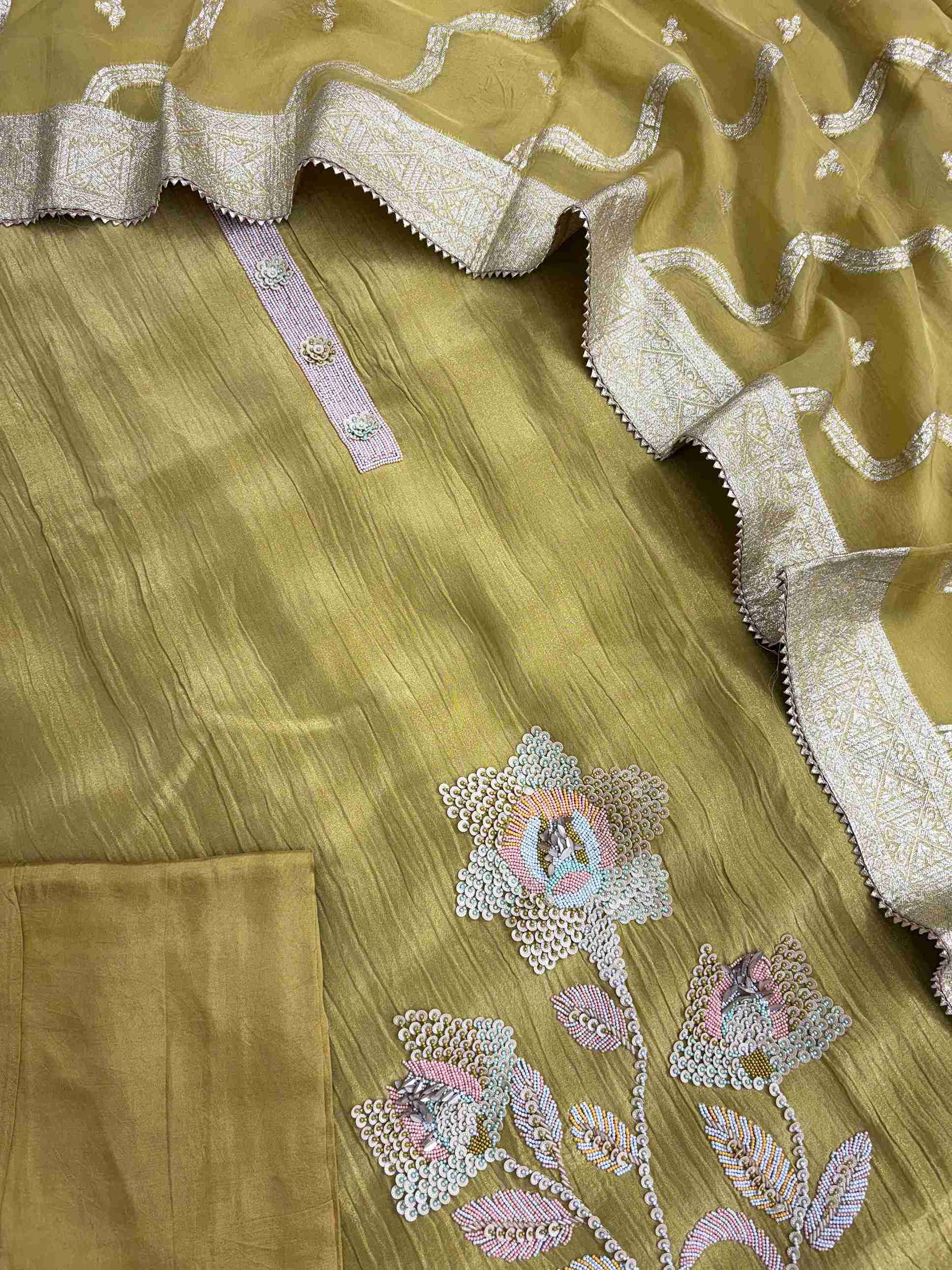 Complete olive gold crushed tissue unstitched suit flat lay set with shirt, banarasi dupatta, and opada silk bottom