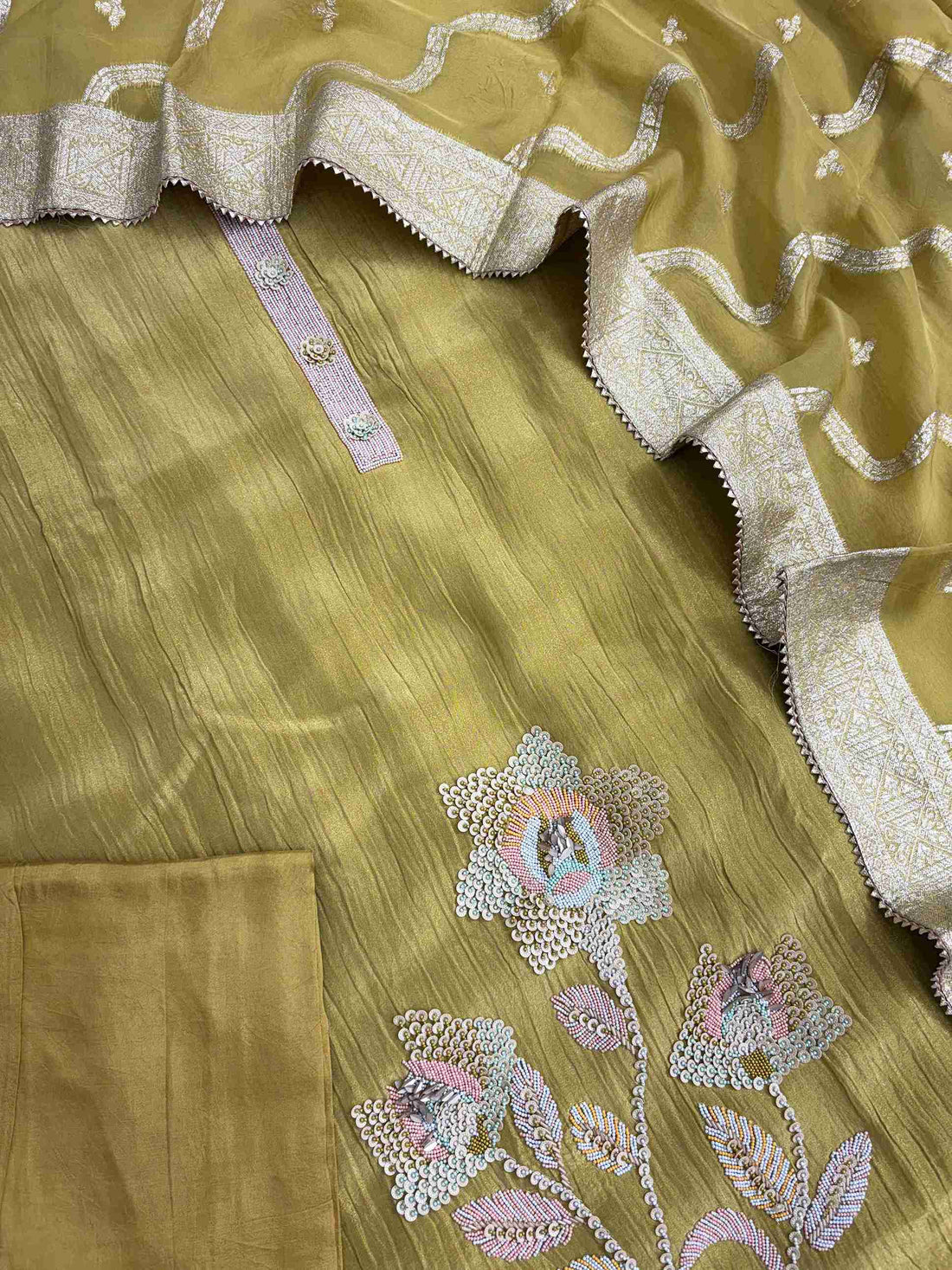 Complete olive gold crushed tissue unstitched suit flat lay set with shirt, banarasi dupatta, and opada silk bottom