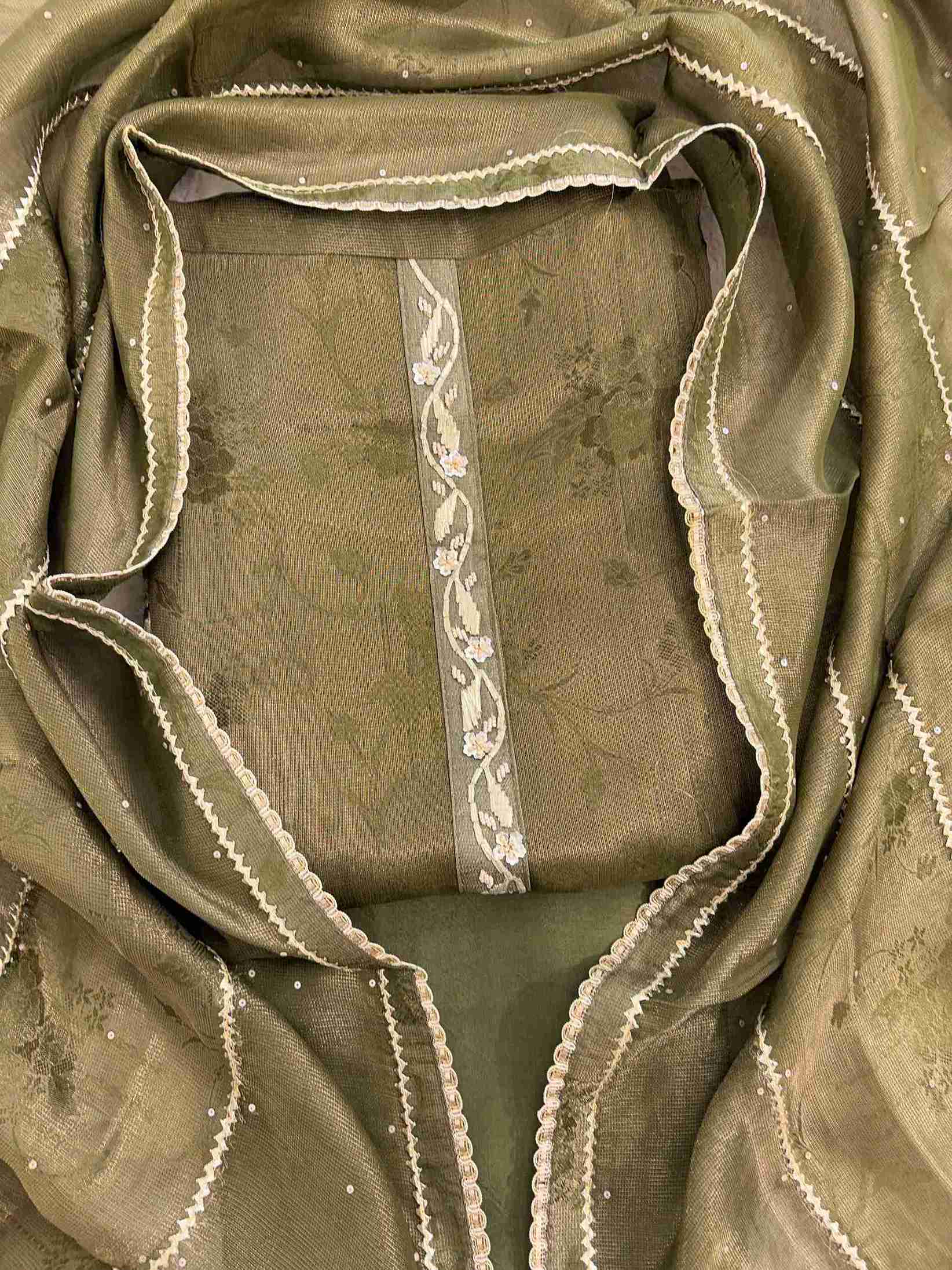 Close-up of gota neckline on olive green Burberry tissue suit