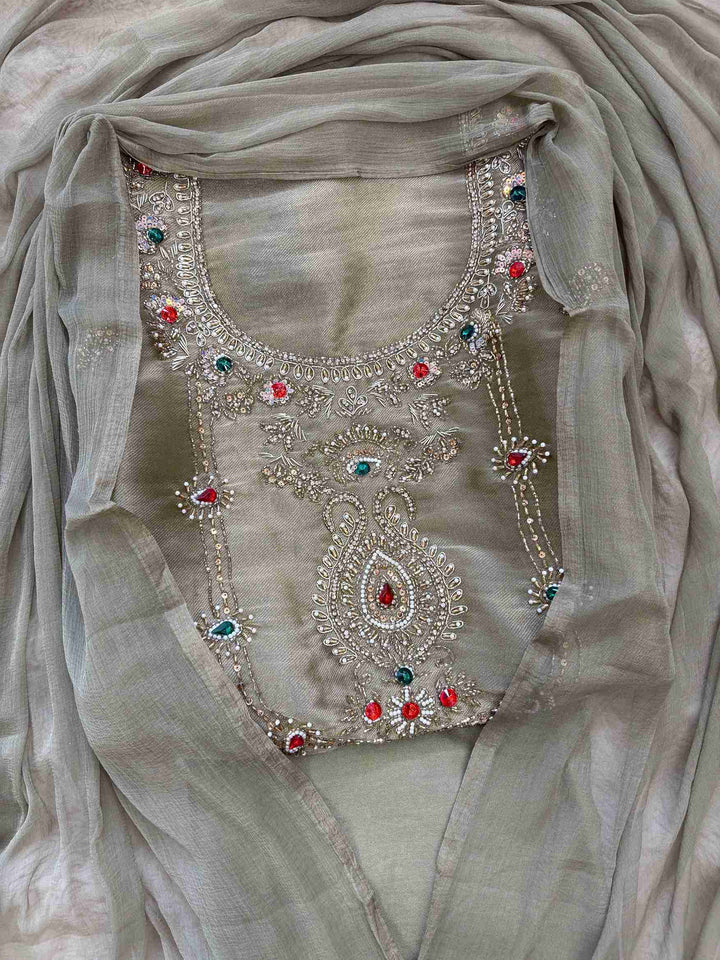 Olive green simmar tissue unstitched suit set flatlay with dupatta and bottom