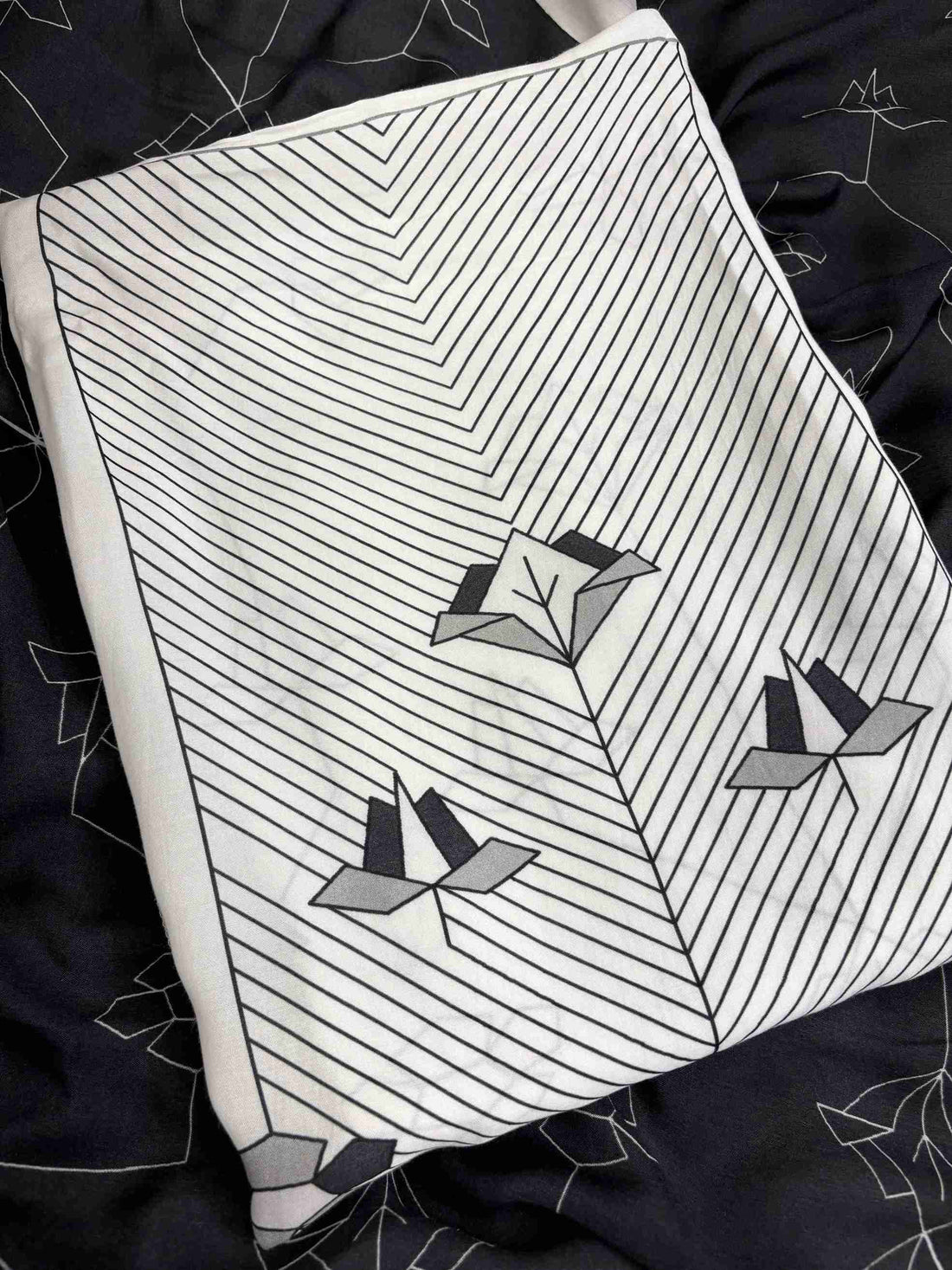 Close up of organza scalloped resham embroidery border on neckline on white and black muslin suit