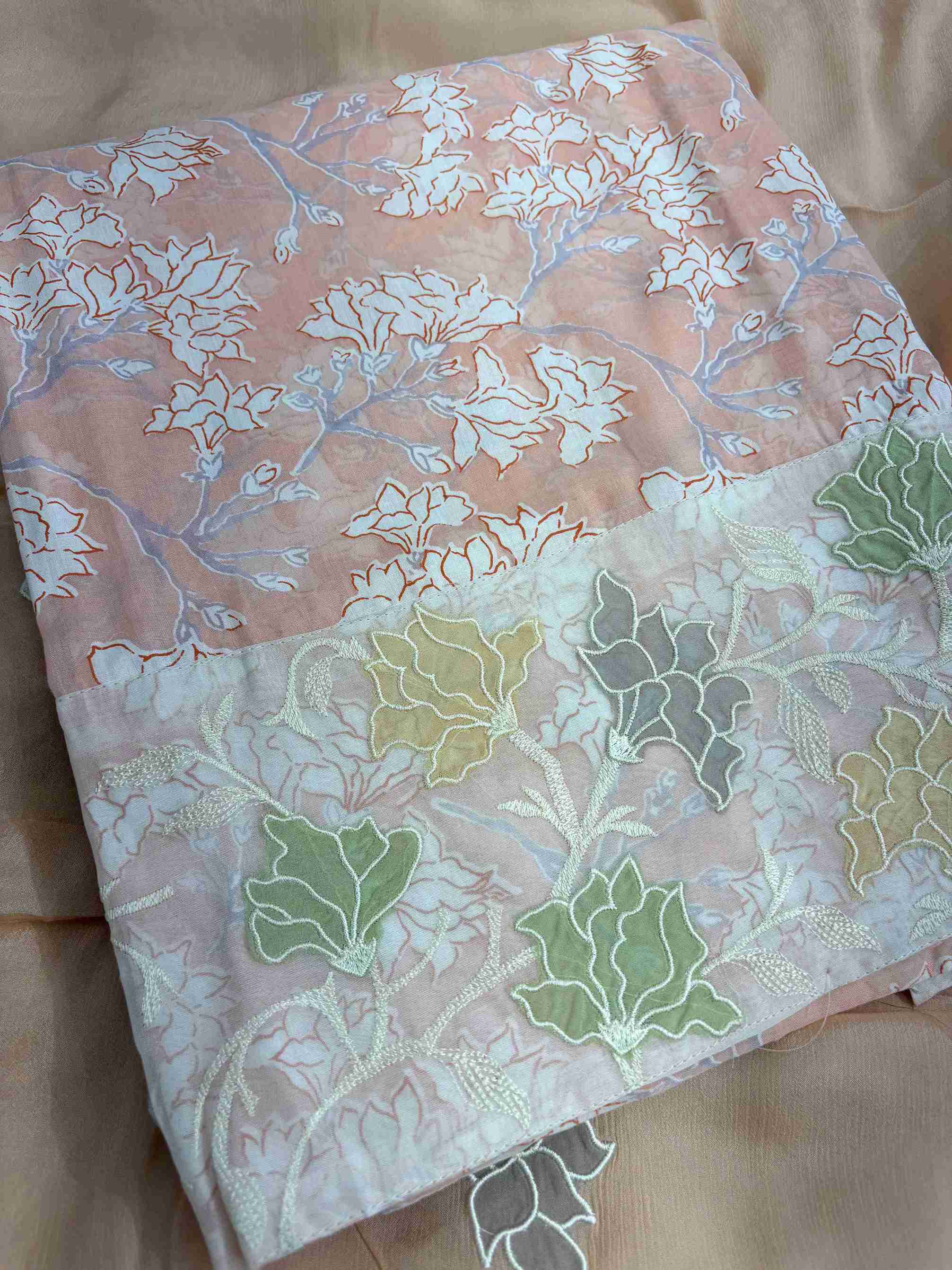 Lace highlighting detail at daaman hemline of peach floral printed cotton shirt
