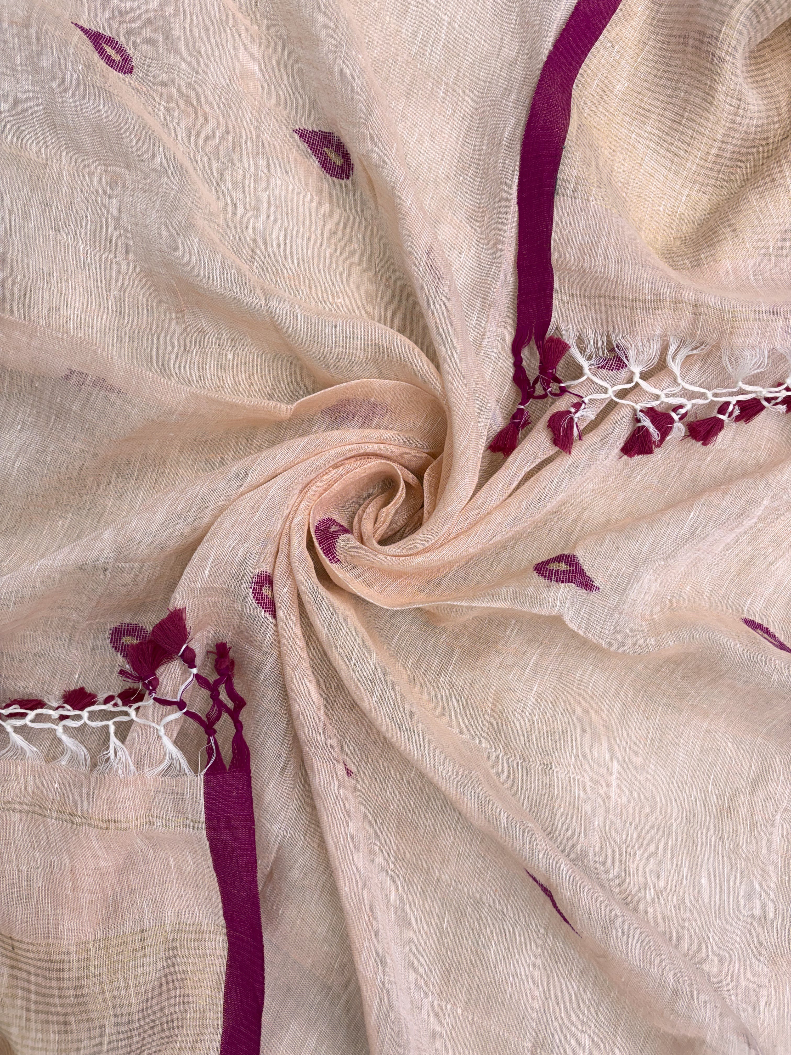 Scattered small pink paisley woven motifs across peach linen dupatta surface