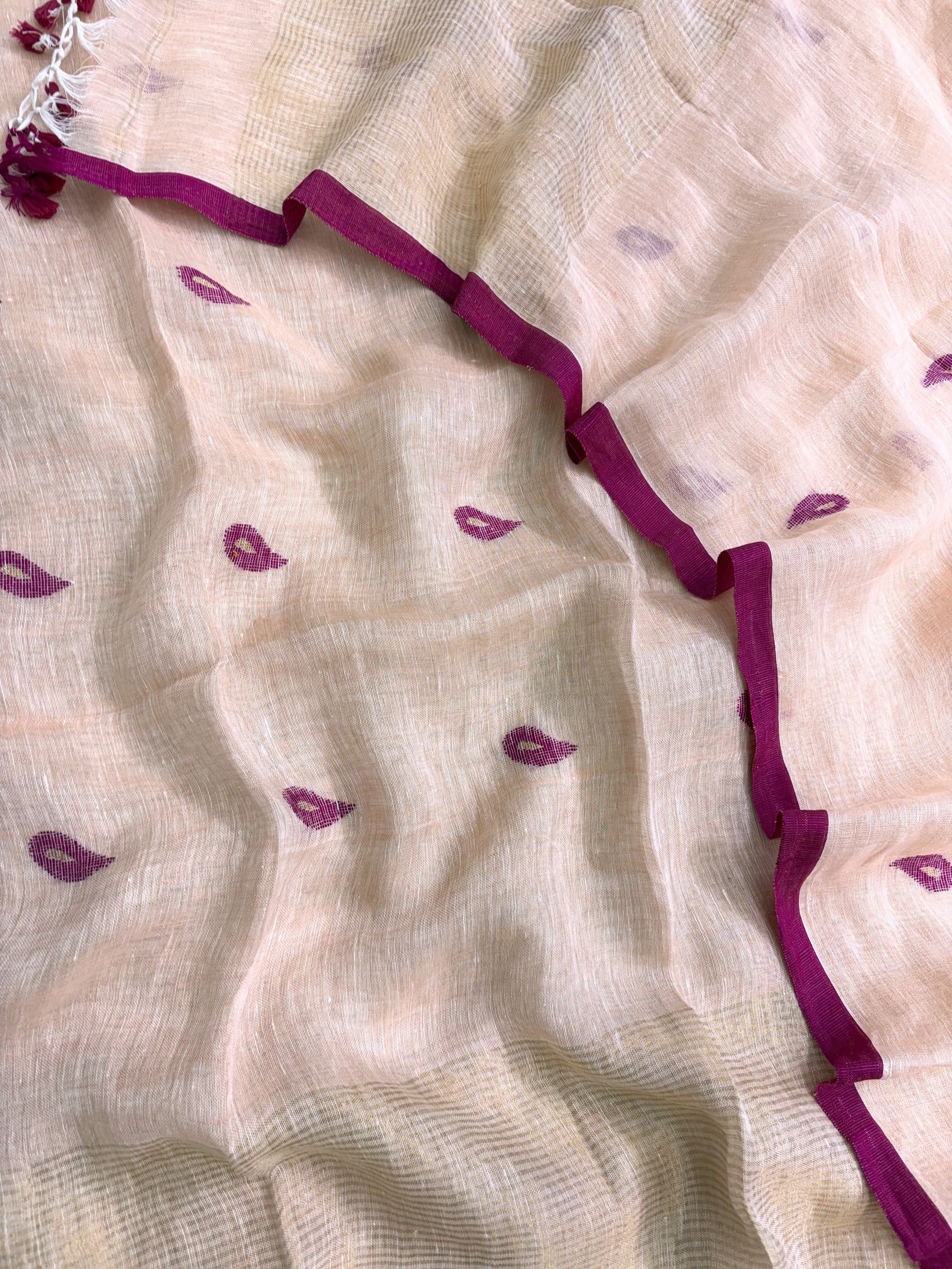 Scattered small pink paisley woven motifs across peach linen shirt body