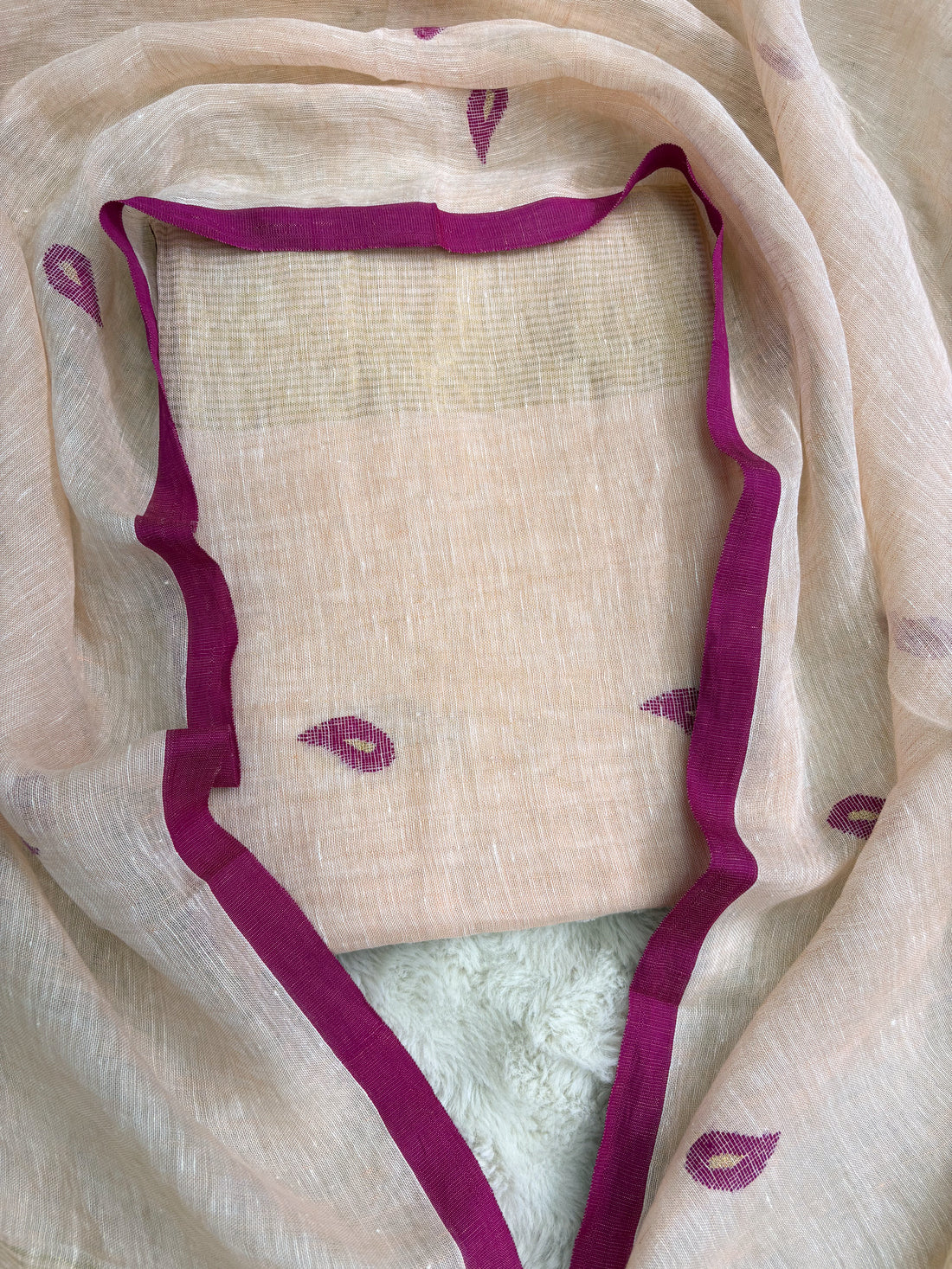 Complete peach linen unstitched 2-piece suit flat lay with shirt and dupatta showing pink paisley motifs and golden stripe