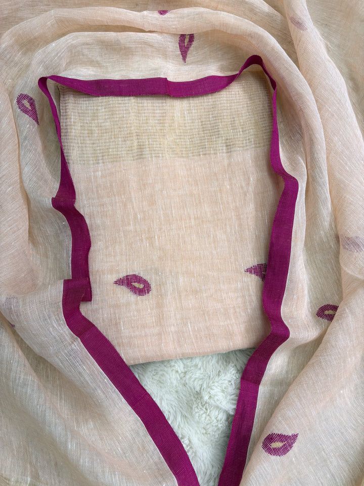 Complete peach linen unstitched 2-piece suit flat lay with shirt and dupatta showing pink paisley motifs and golden stripe