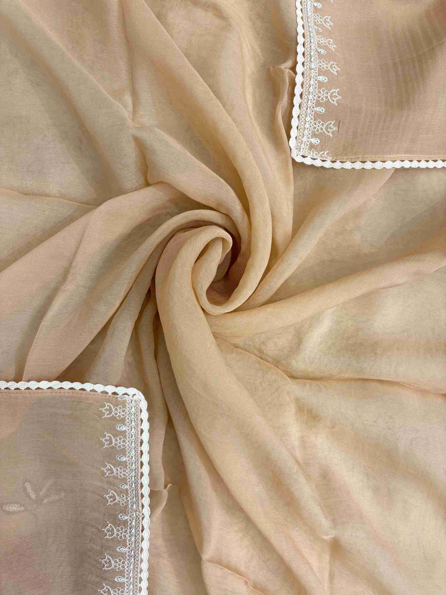 White floral applique motifs at corner of peach mul cotton dupatta
