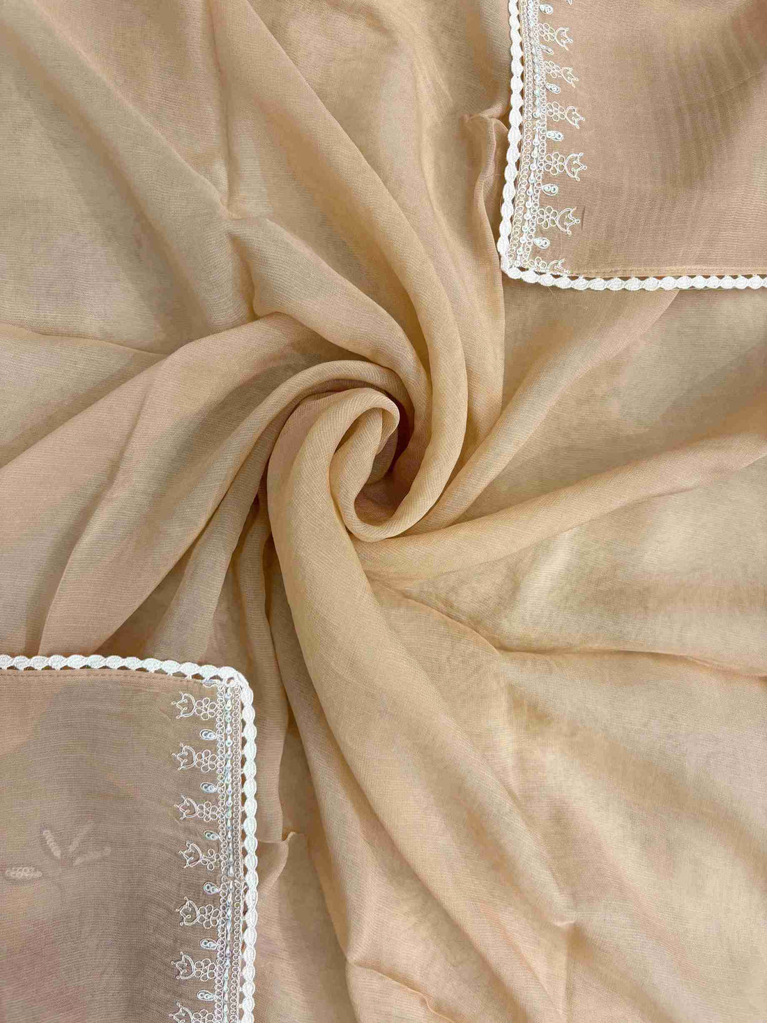 White floral applique motifs at corner of peach mul cotton dupatta