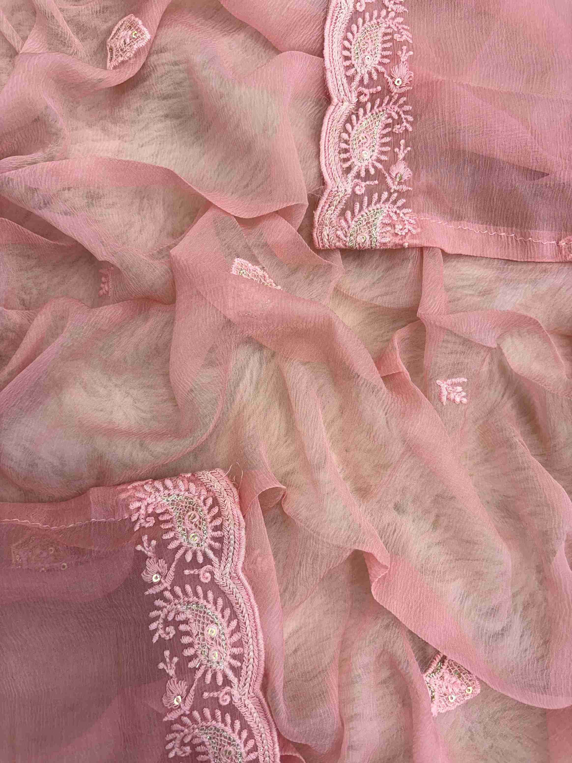 Chikankari border with scalloped finishing along peach pink chiffon dupatta edge