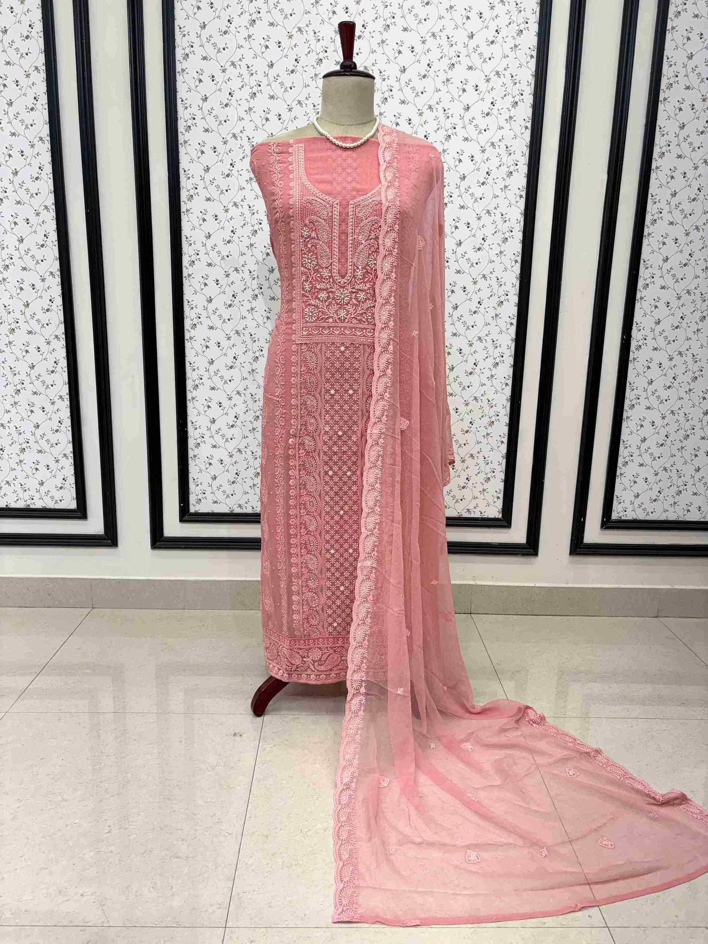 Scattered chikankari floral motifs across the surface of peach pink chiffon dupatta
