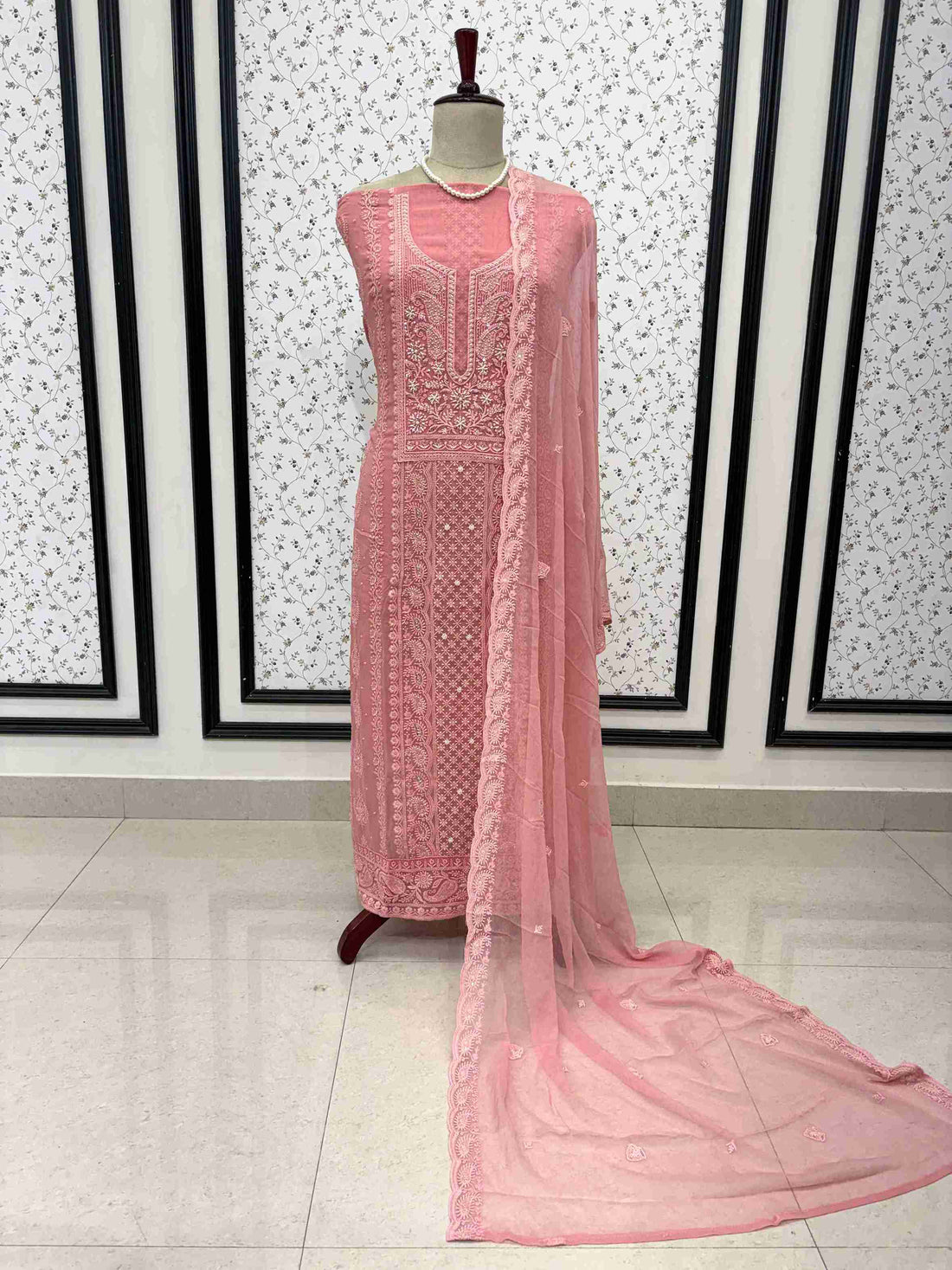 Scattered chikankari floral motifs across the surface of peach pink chiffon dupatta