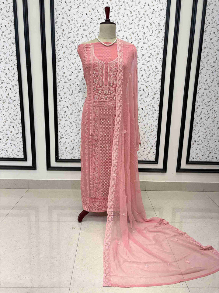 Scattered chikankari floral motifs across the surface of peach pink chiffon dupatta