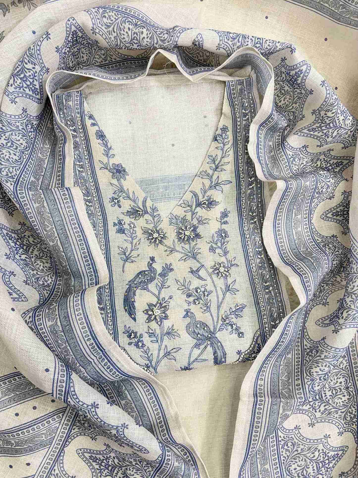 Printed peacock and floral neckline panel with sequin accents on pearl grey linen shirt