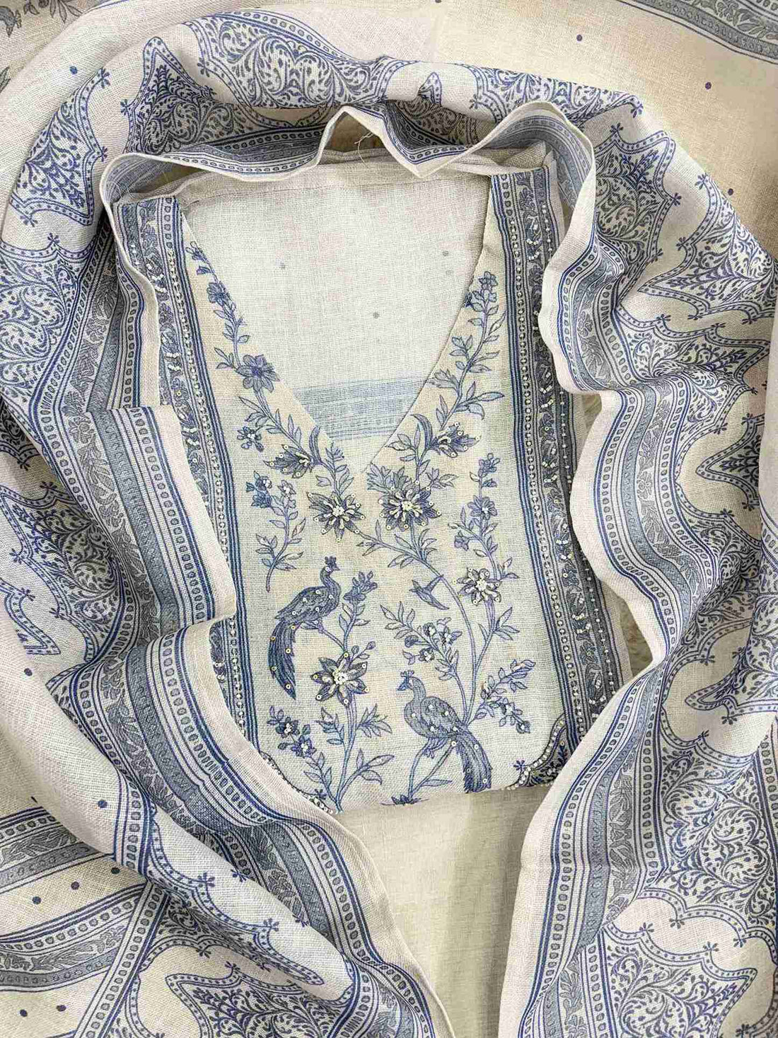 Printed peacock and floral neckline panel with sequin accents on pearl grey linen shirt
