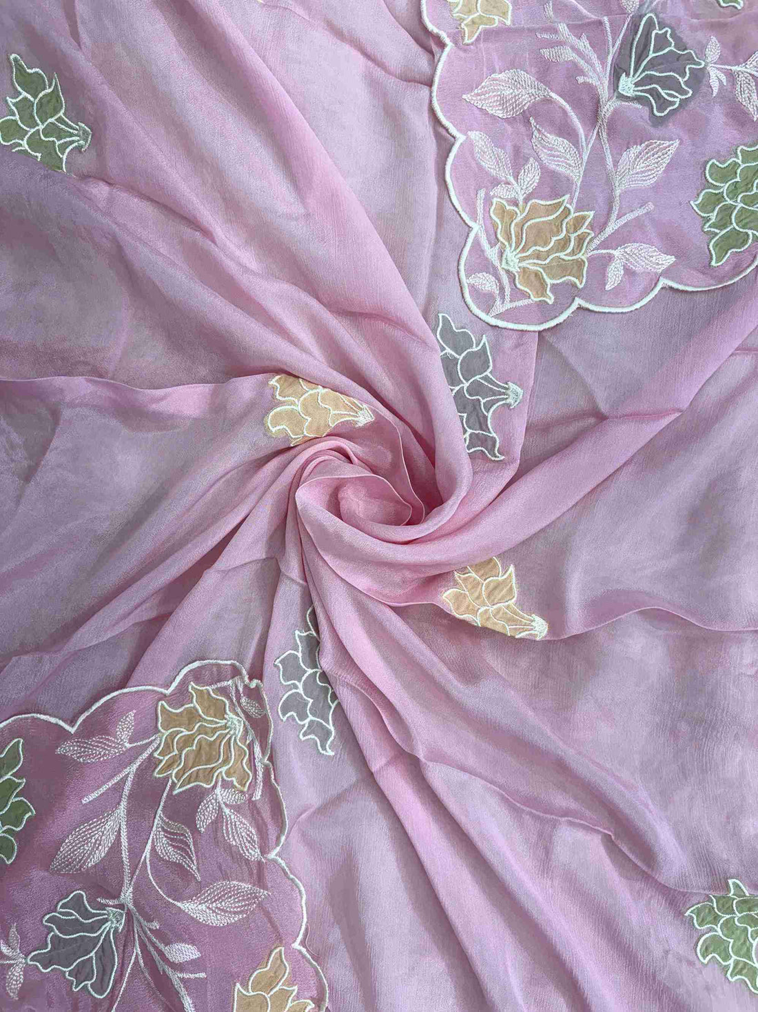 Applique floral motif highlighted with thread embroidery at center of pink chinnon dupatta