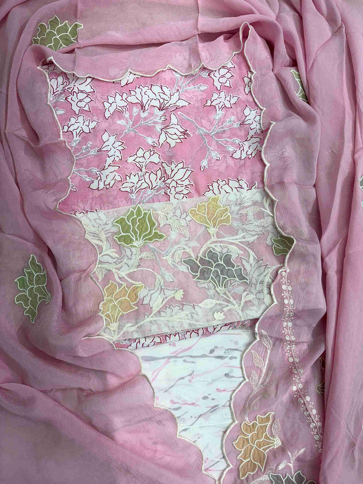 Close-up of all-over white floral print with blooming clusters and branches on pink cotton shirt body