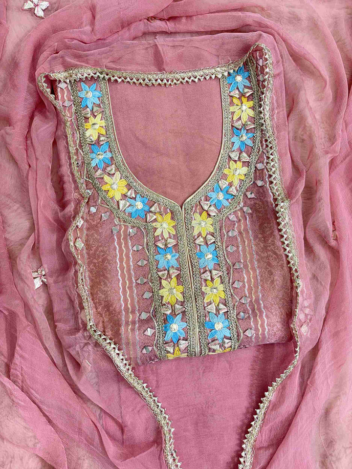 Gota floral motifs, mirror motifs, and vertical gota lanes across the full length panel of pink shimmer tissue shirt