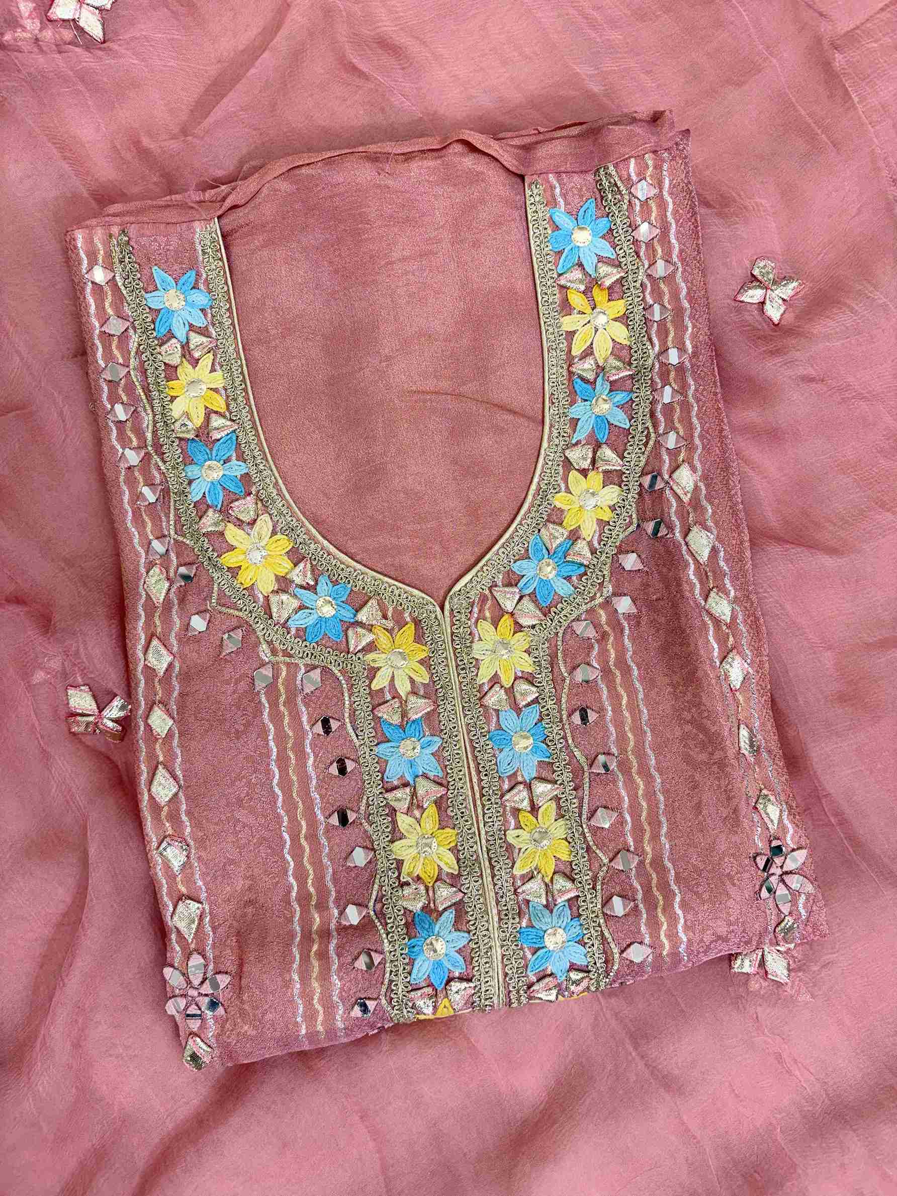 Multicolor thread floral motifs with mirror work and gota highlighting at neckline of pink shimmer tissue shirt