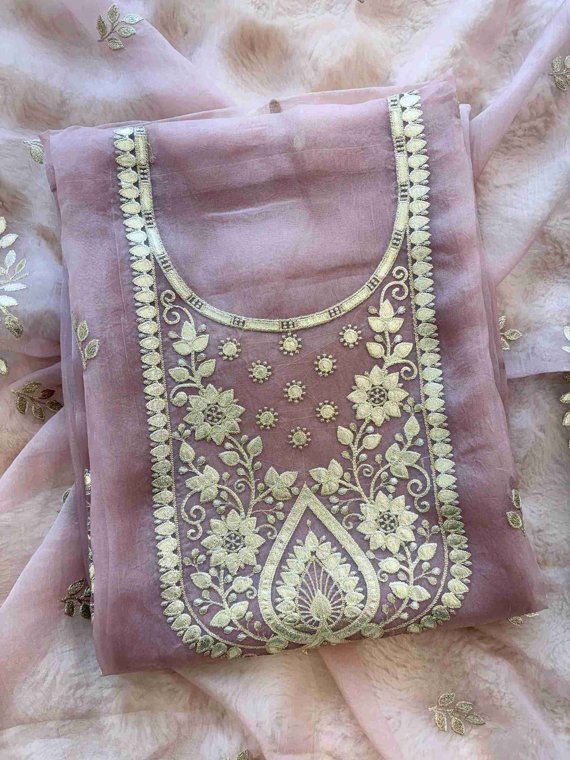Leather gota border on the hemline of pink shimmer tissue suit