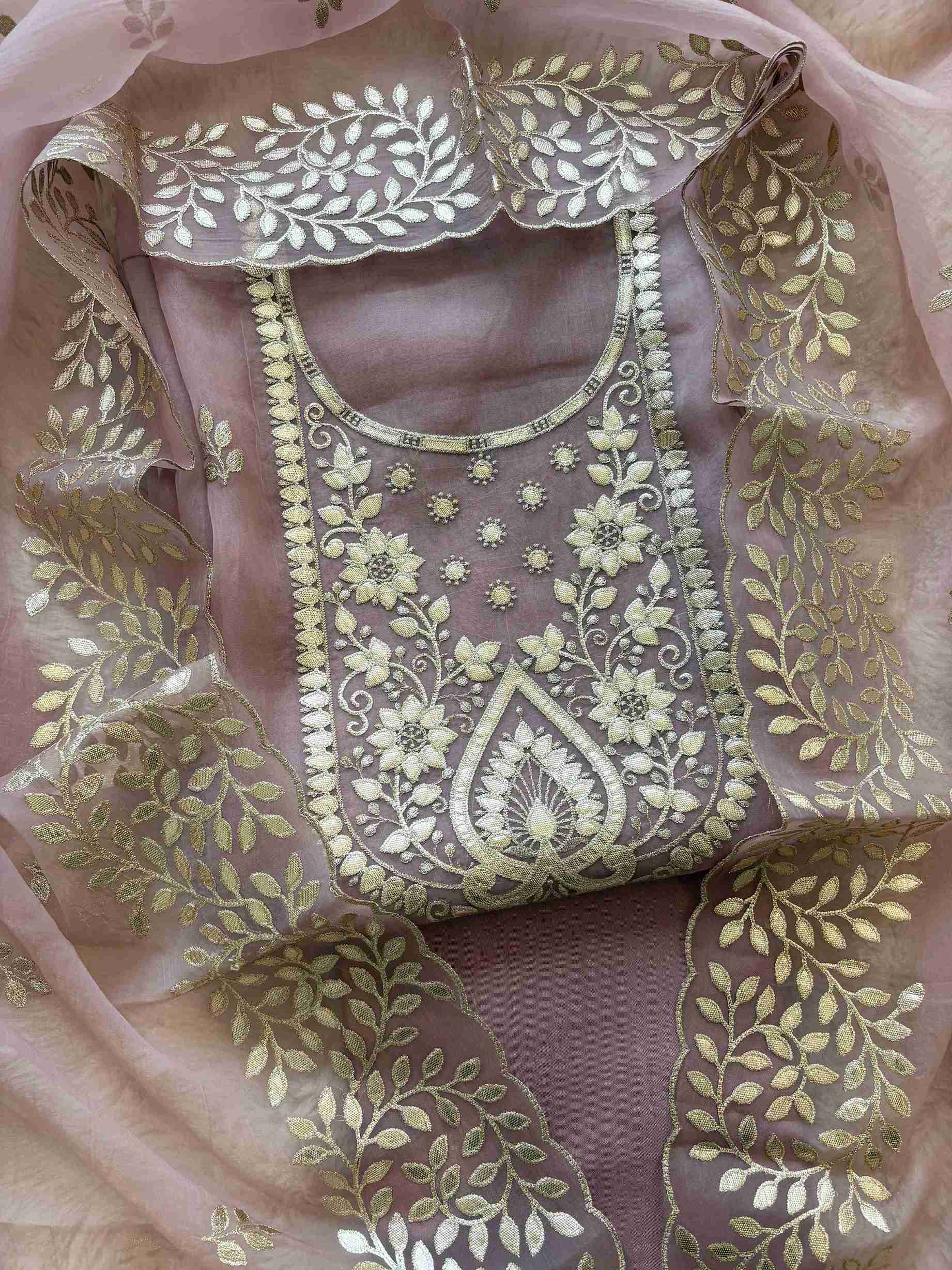 Close-up of leather gota work neckline on pink shimmer tissue suit