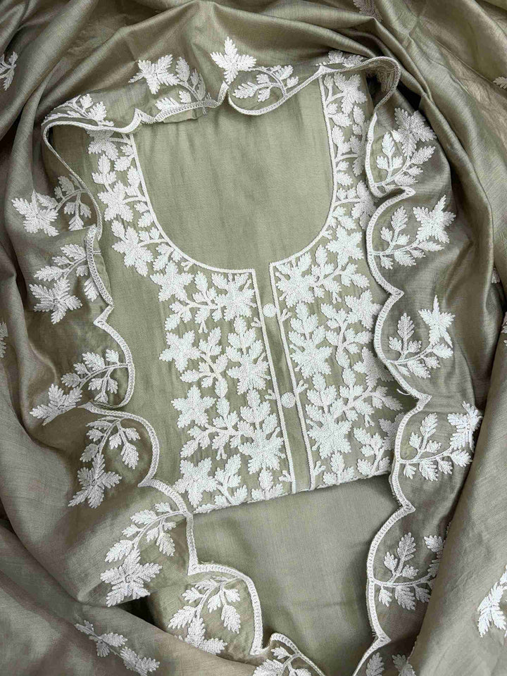 Scattered crotia floral motifs across pista green jaam cotton shirt body with crotia lace hemline border