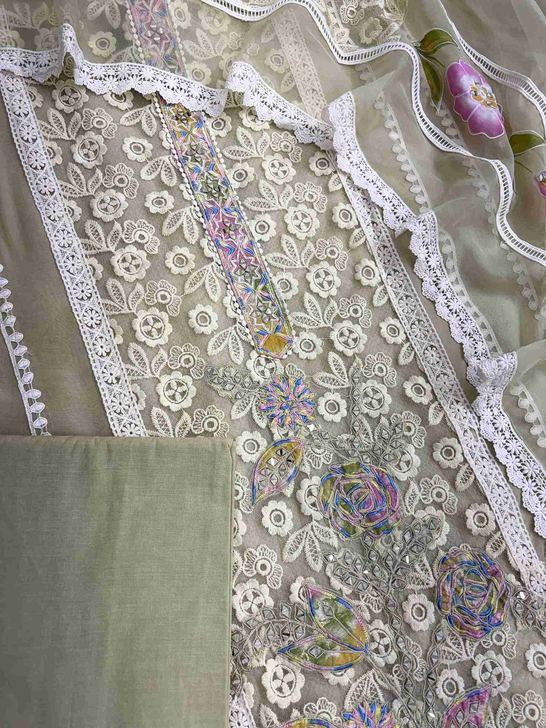 Complete pista green organza unstitched suit flat lay set with lace panel shirt, dupatta, and matching bottom
