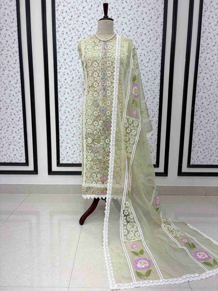 Pista green organza unstitched suit full front view with hand-painted floral dupatta draped on mannequin