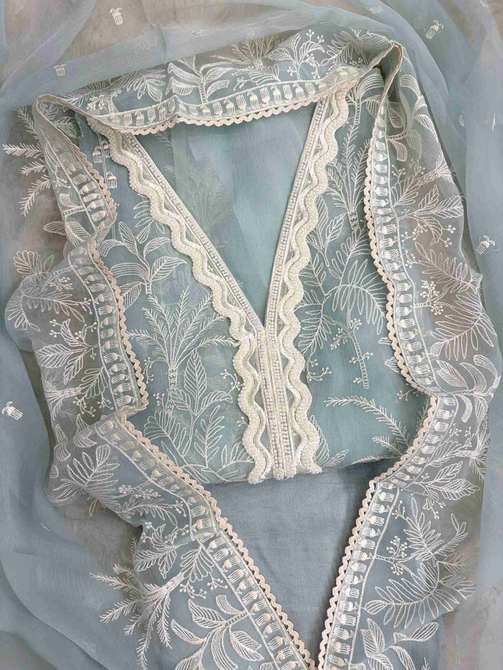 Powder blue poly chiffon suit front view with resham embroidery and lace V neckline