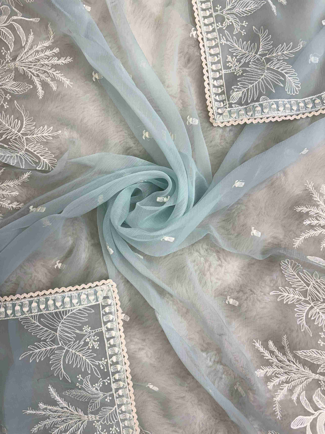 Powder blue embroidered suit showcasing scattered resham thread booties