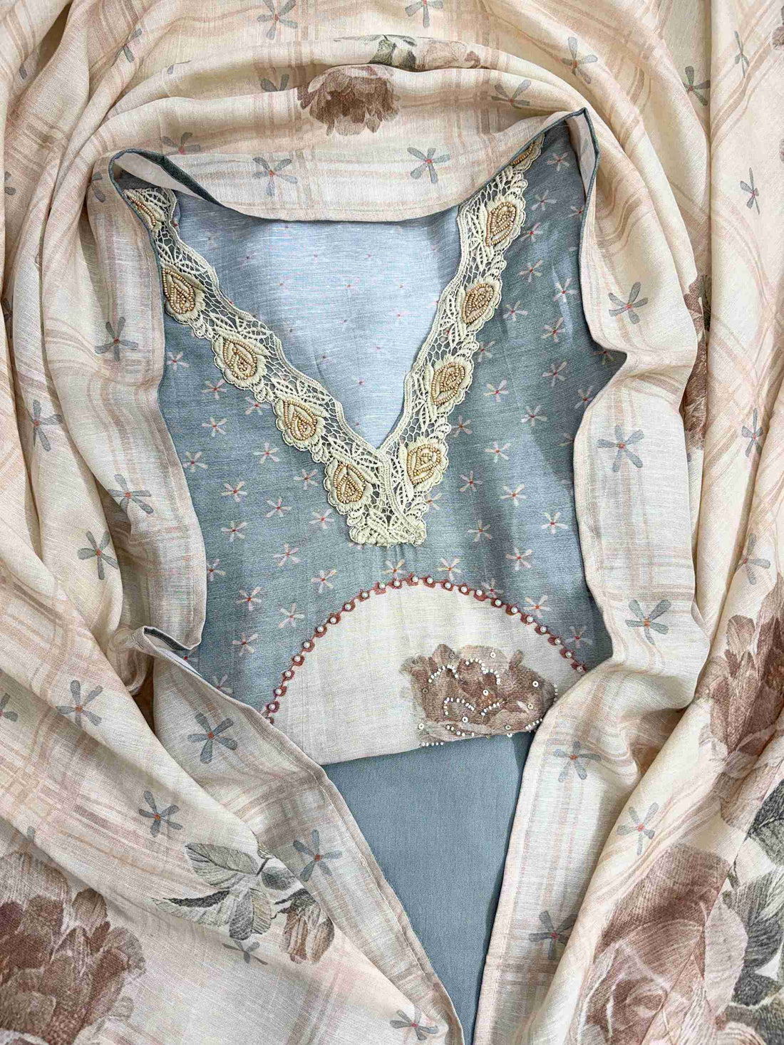 Complete powder grey linen cotton unstitched suit flat lay set with shirt, narrow dupatta, and cotton silk bottom