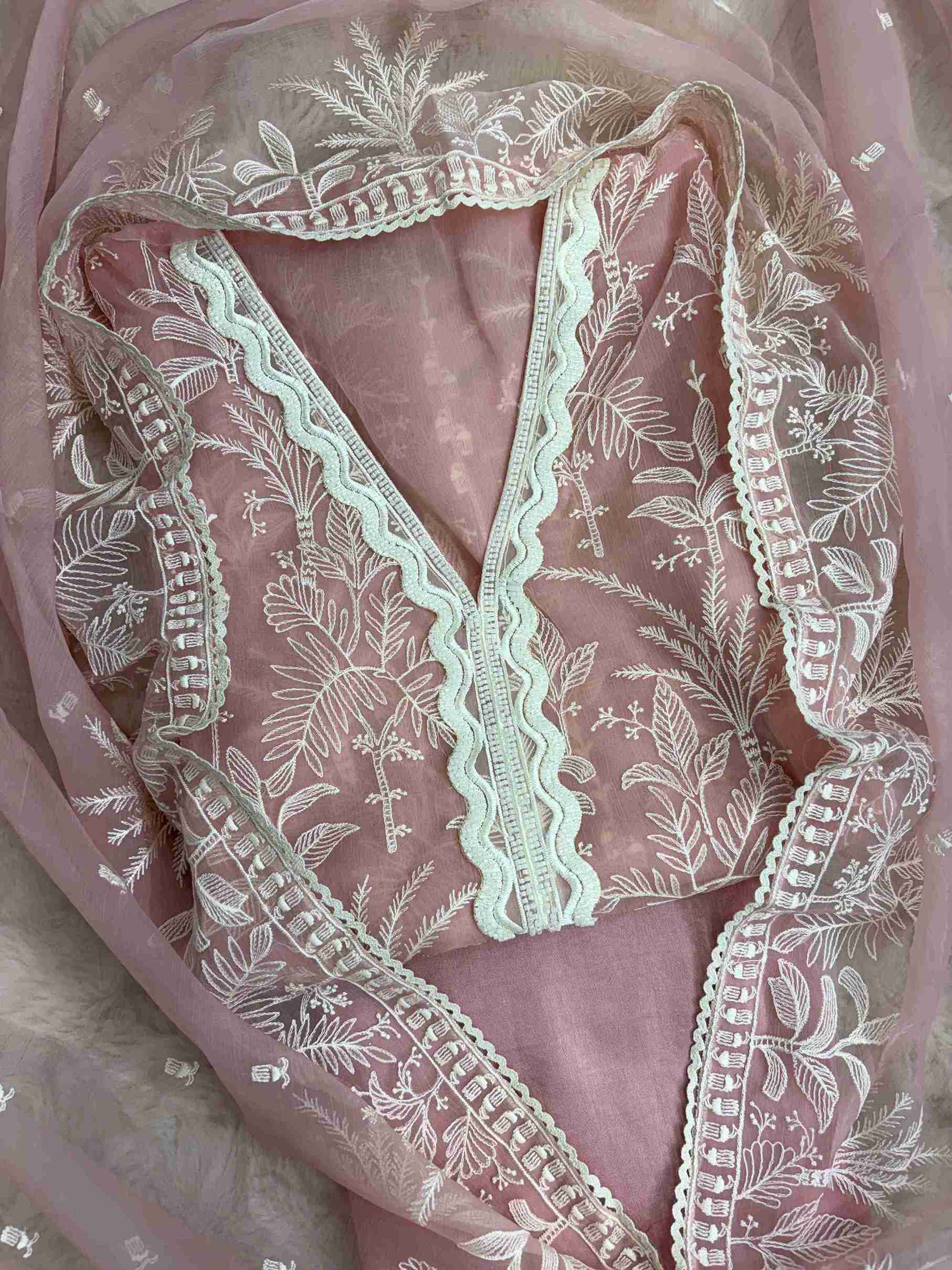 Powder pink poly chiffon suit front view with resham embroidery and lace V neckline