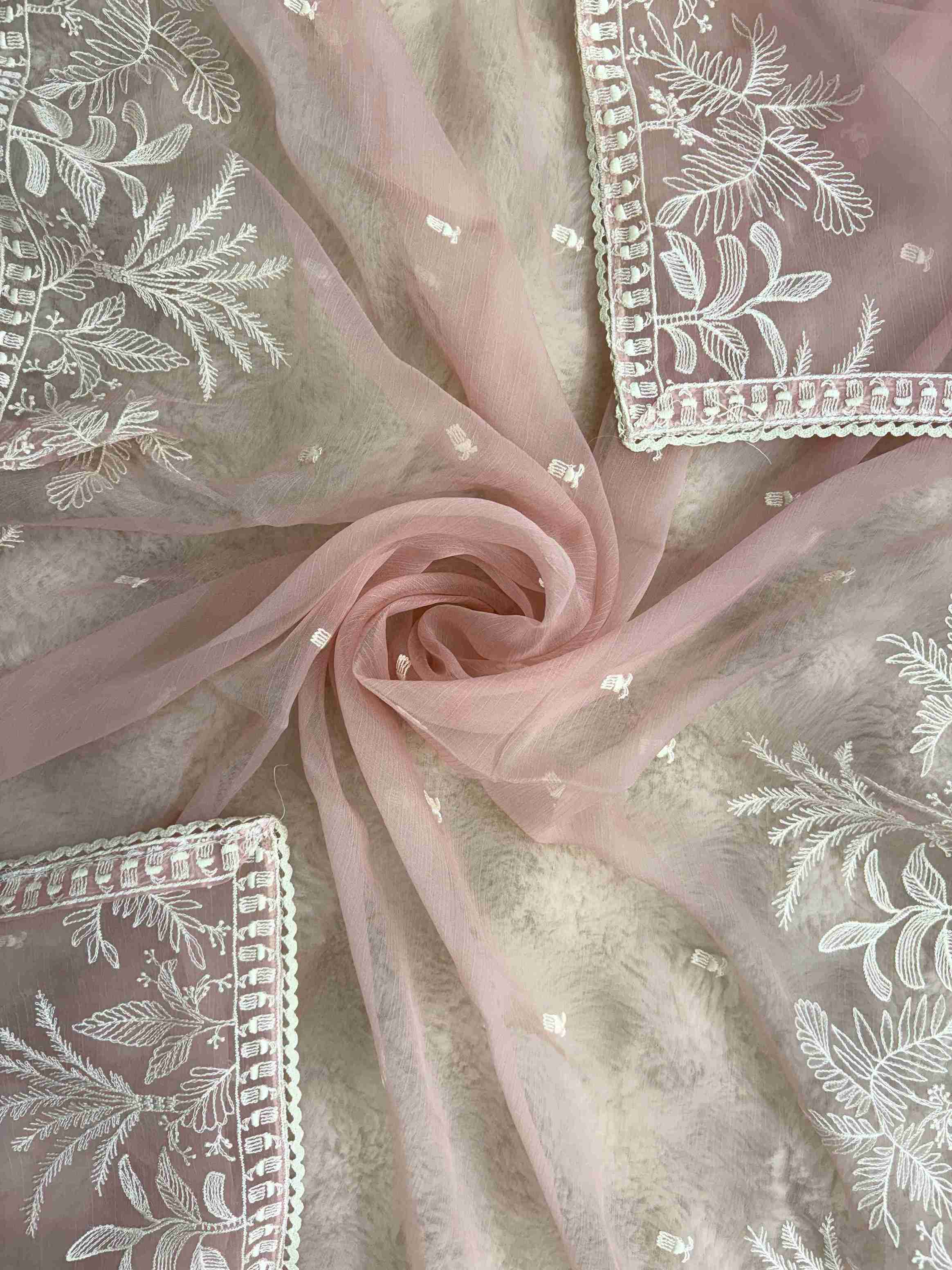 Powder pink embroidered suit showcasing scattered resham thread booties