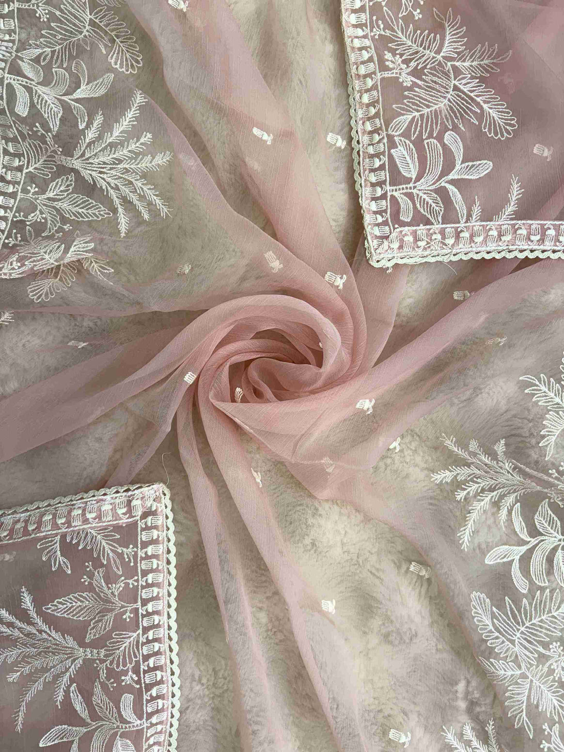 Powder pink embroidered suit showcasing scattered resham thread booties