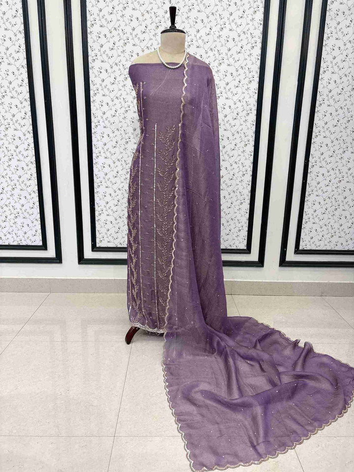 Purple burberry tissue unstitched suit displayed on mannequin with heavy nalki and cutdana embroidery