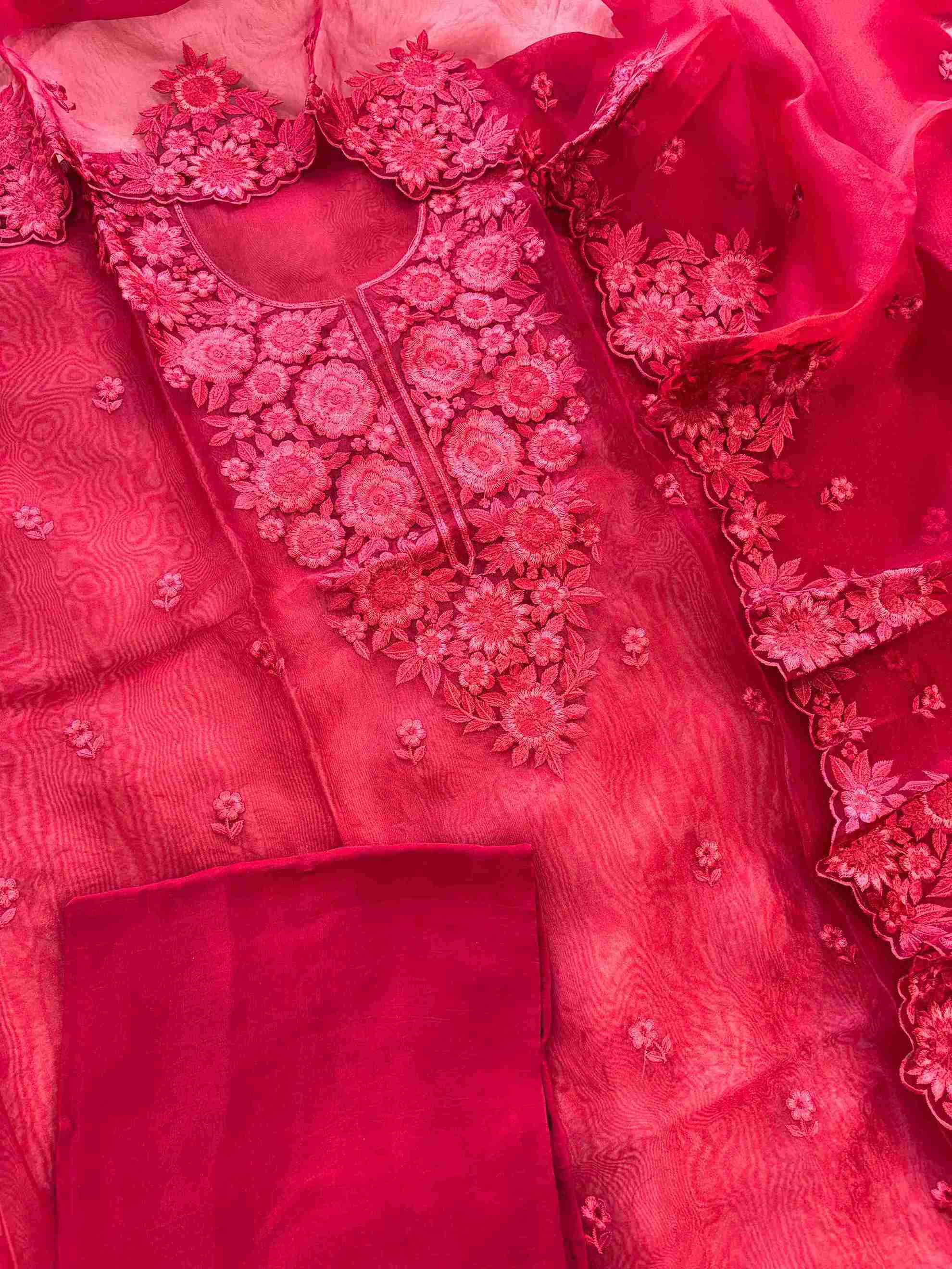 Red glass organza unstitched suit set flatlay with dupatta and crepe bottom