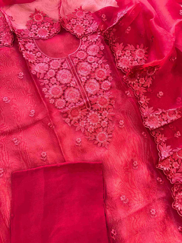 Red glass organza unstitched suit set flatlay with dupatta and crepe bottom
