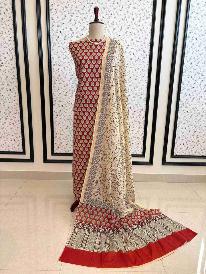 Red and off white pure cotton printed unstitched suit set displayed on mannequin