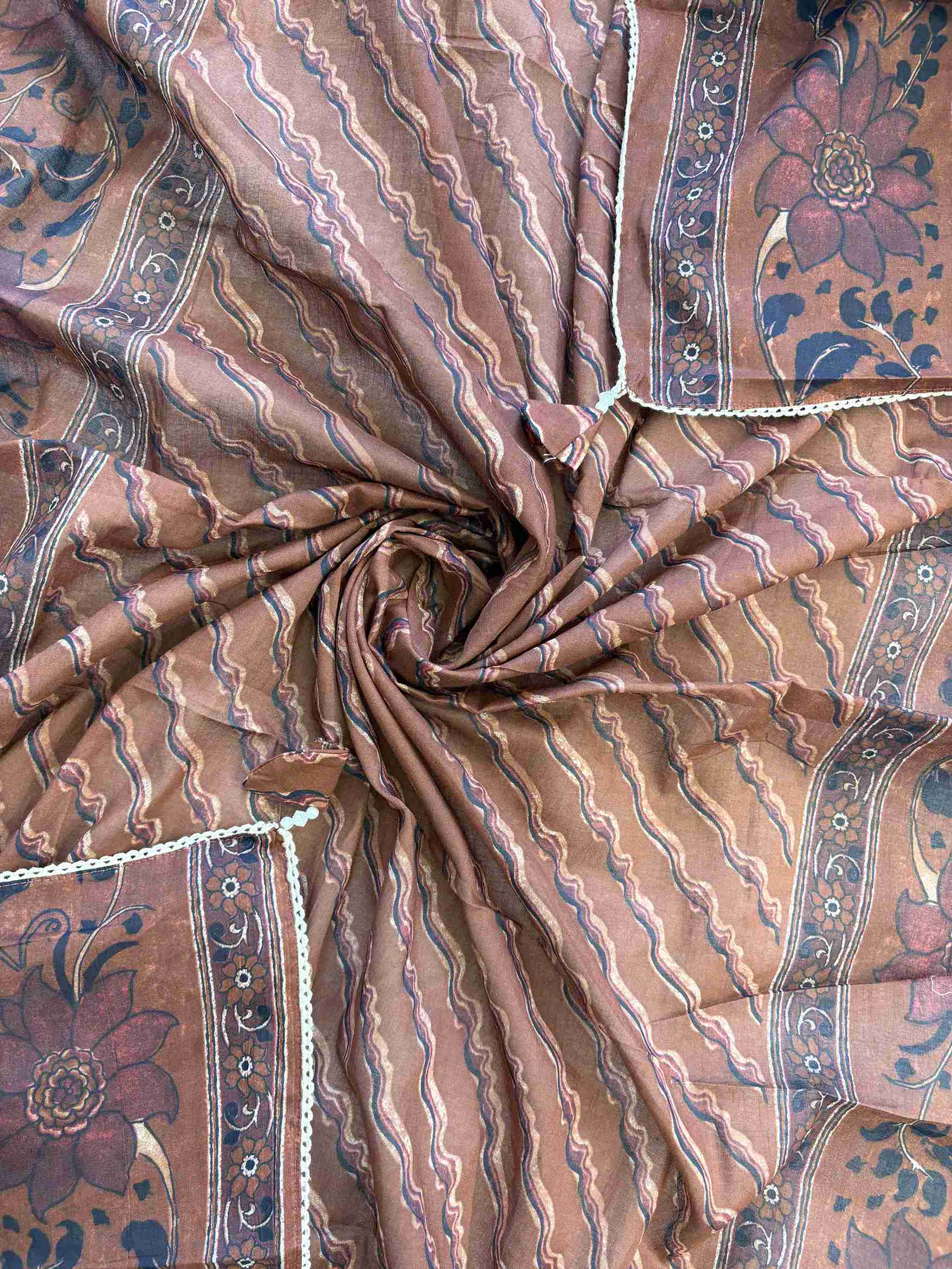 All-over floral print with wave stripe pattern and crotia lace border on rust brown cotton dupatta