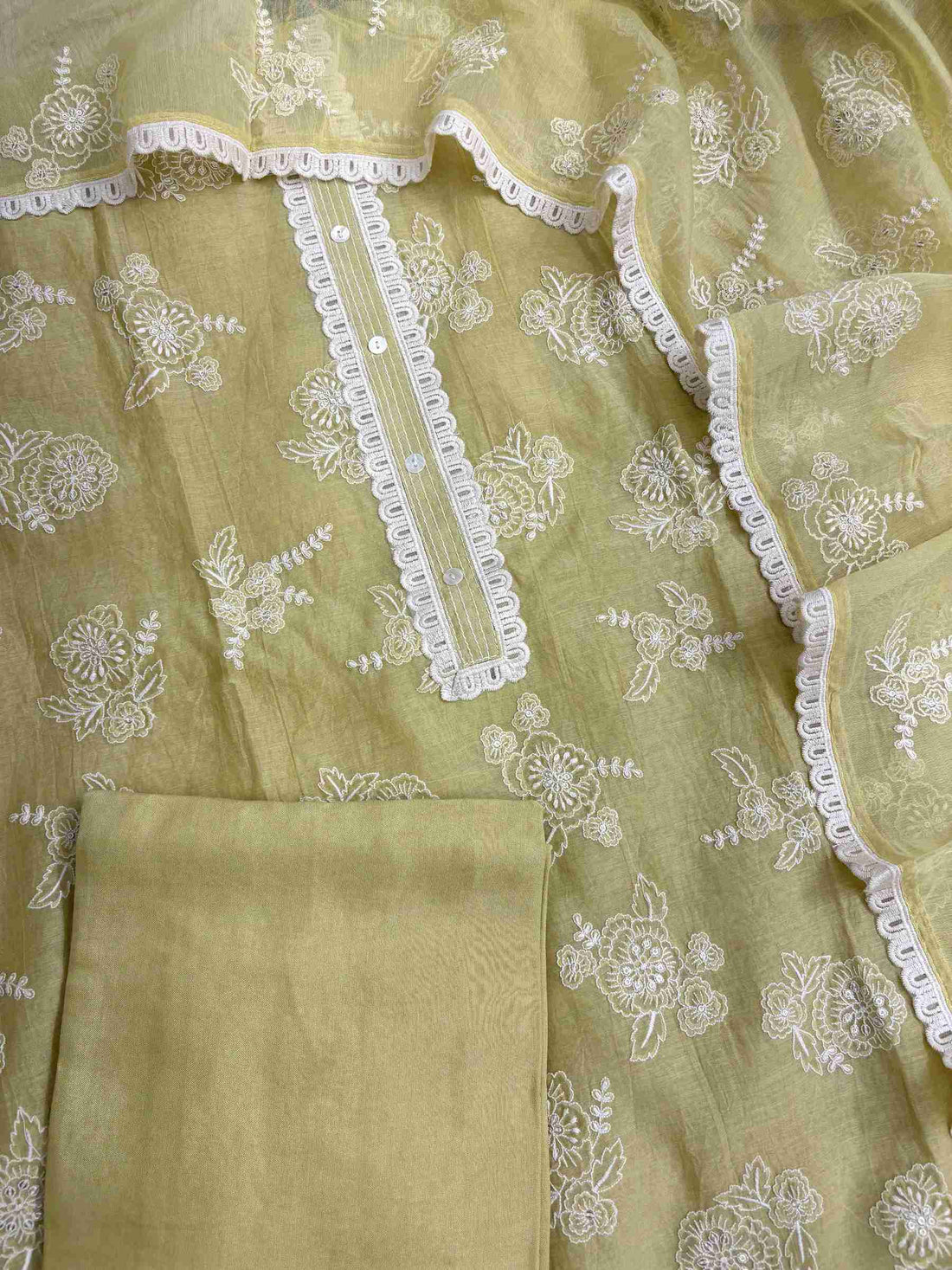 All-over white thread embroidered floral motifs across sage green mul chanderi shirt body