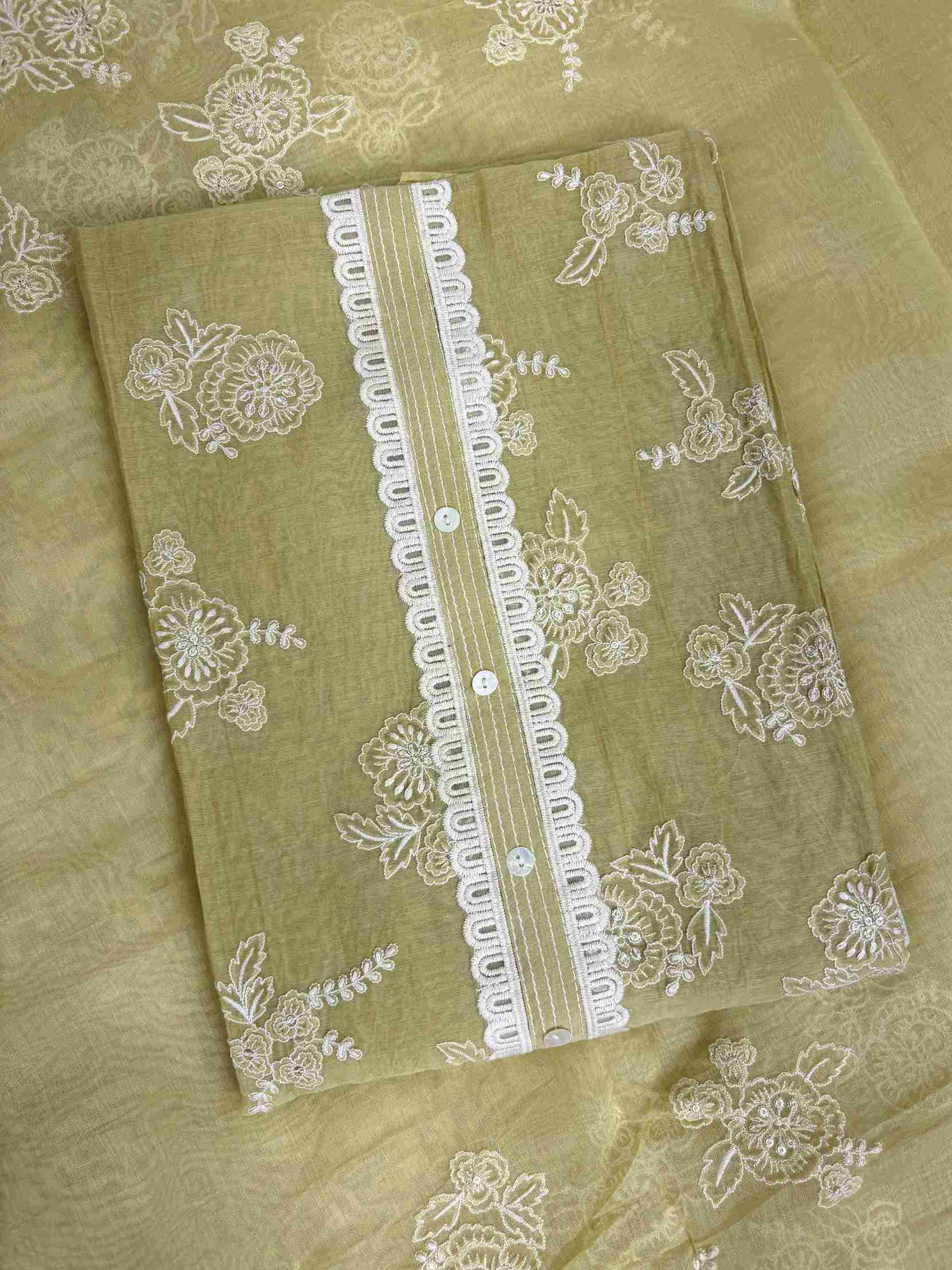 All-over white thread embroidered floral motifs across sage green mul chanderi shirt body