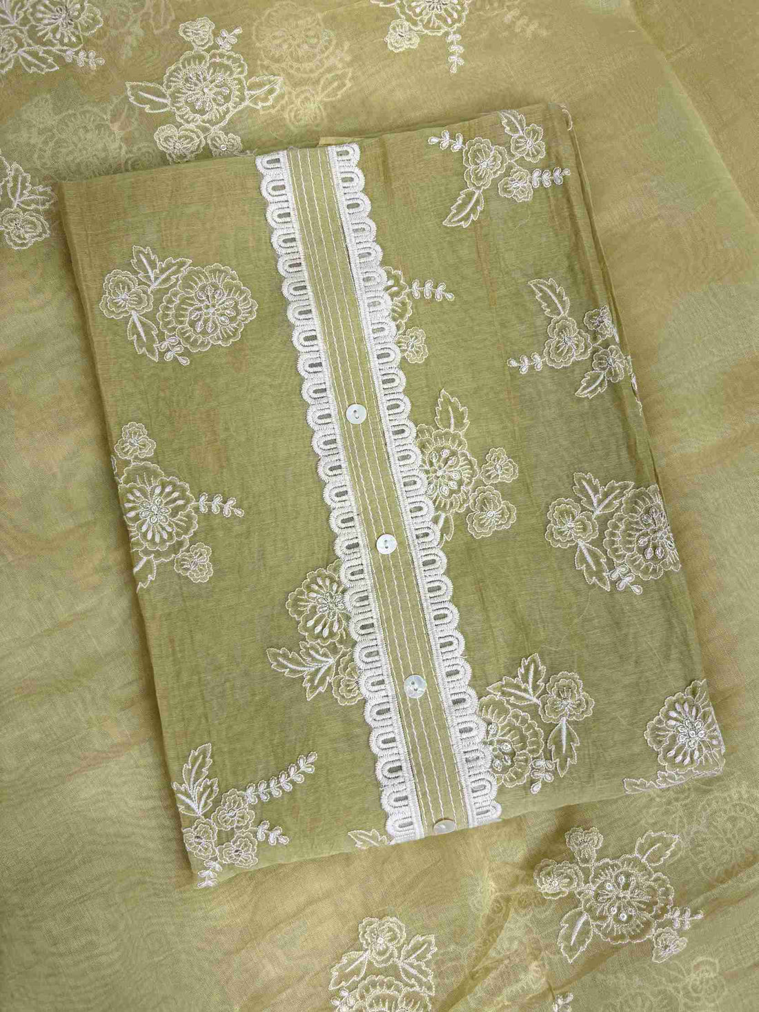 All-over white thread embroidered floral motifs across sage green mul chanderi shirt body